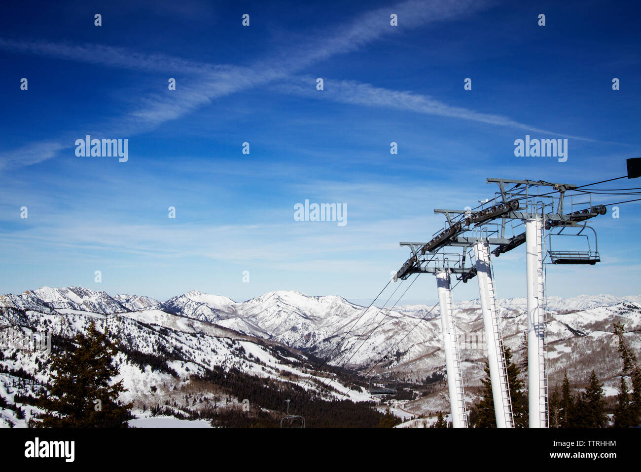 Ski lifts with snow covered Wasatch Mountain range in background Stock Photo