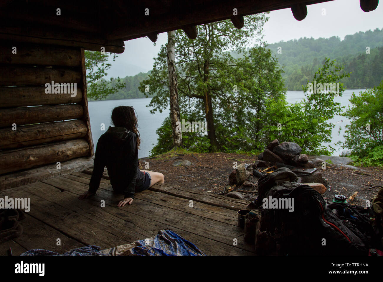 Rear view of woman camping in forest Stock Photo