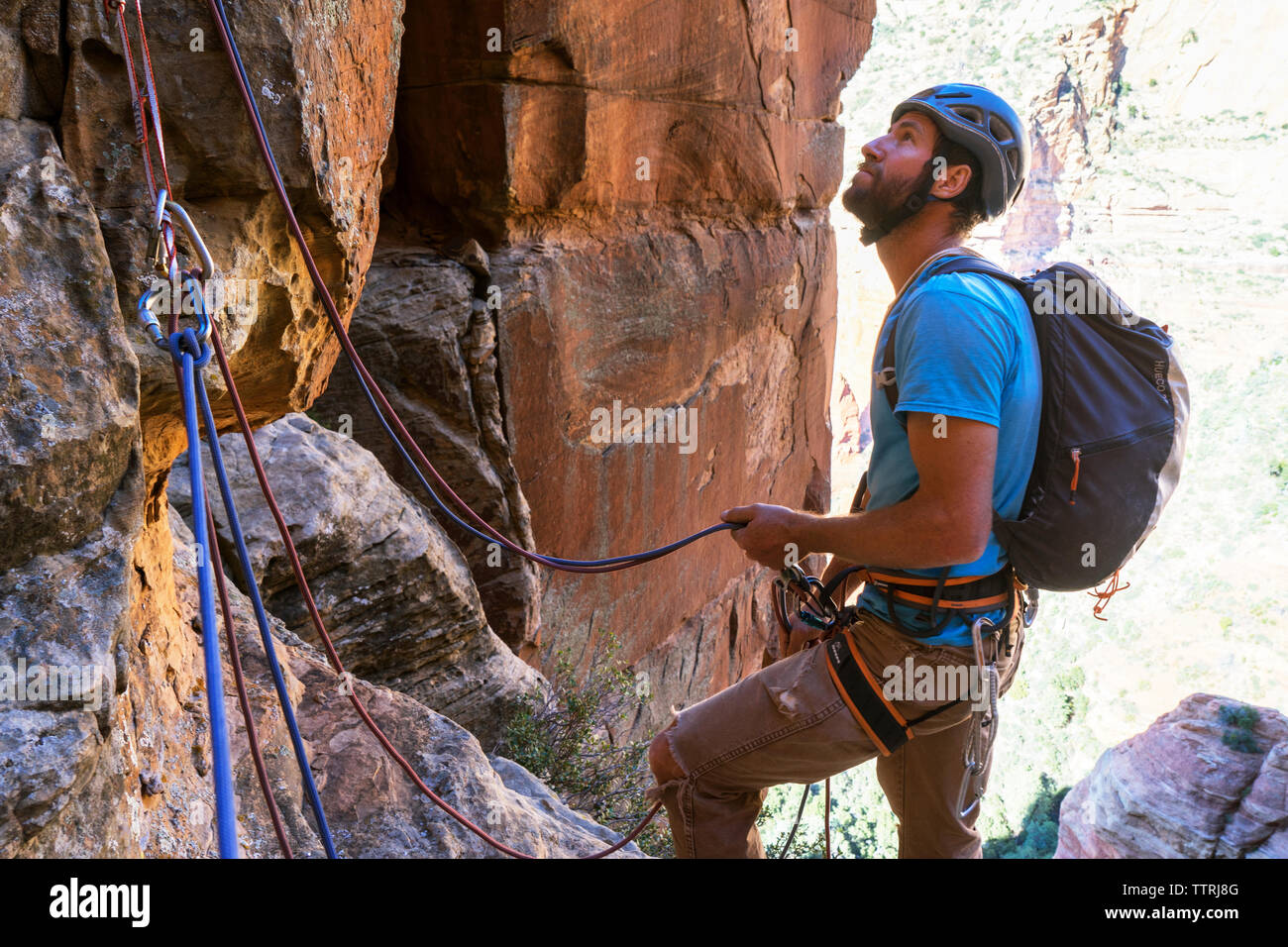 Male hiker climbing mountain Stock Photo