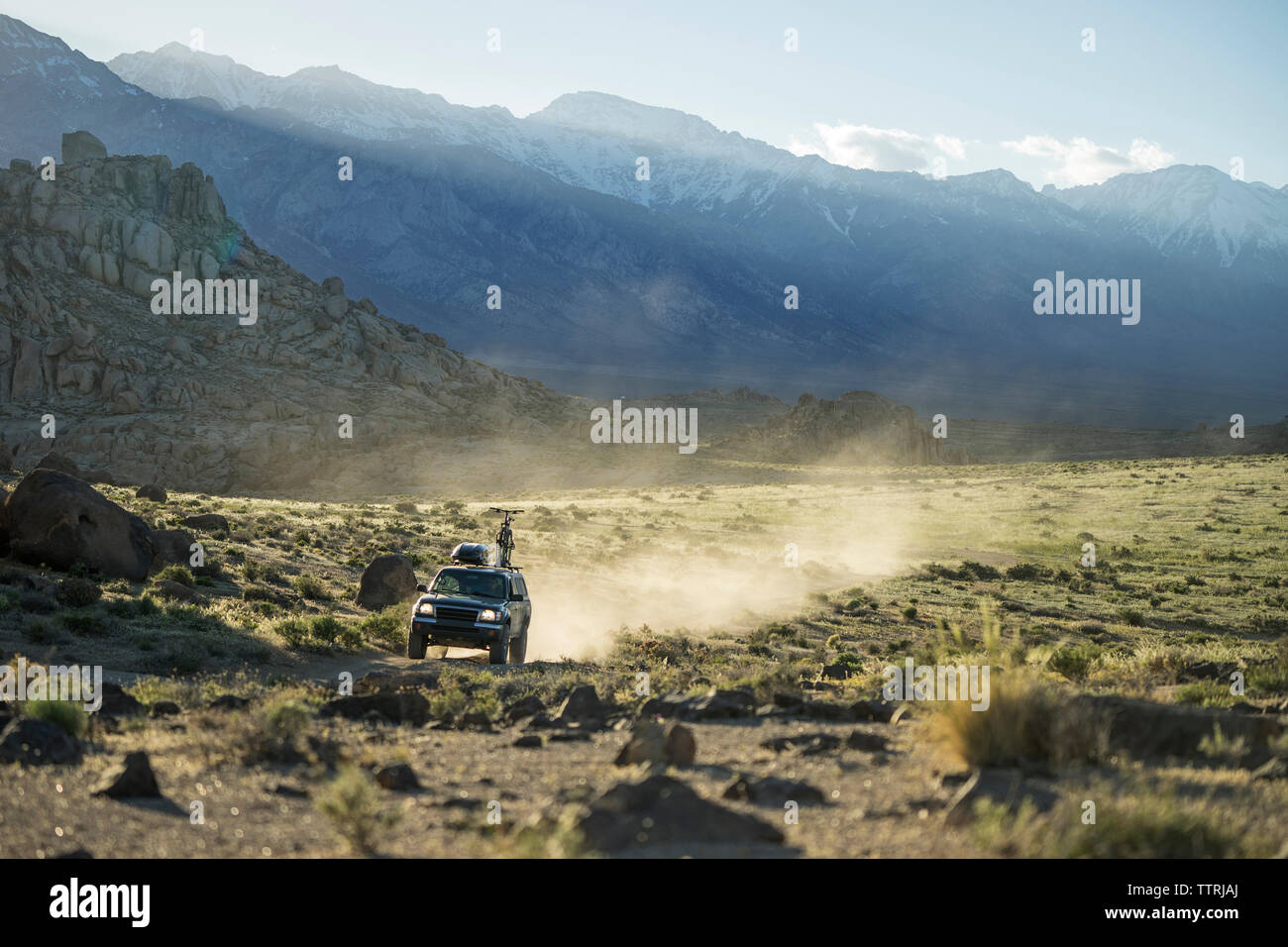 Sports utility vehicle on field against Alabama hills Stock Photo