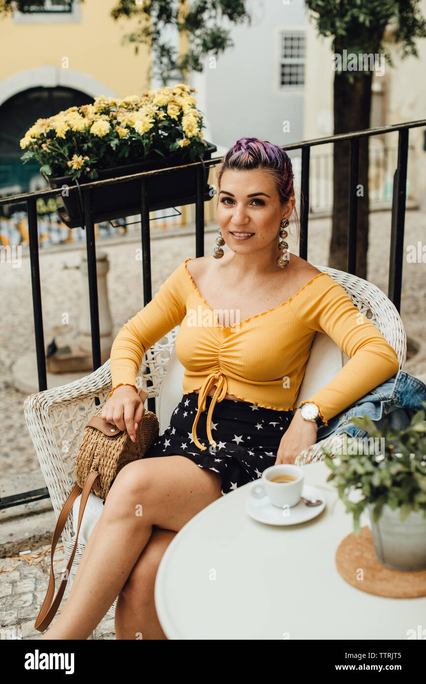 Purple hair girl with a cup of coffee in the street of Lisbon Stock Photo
