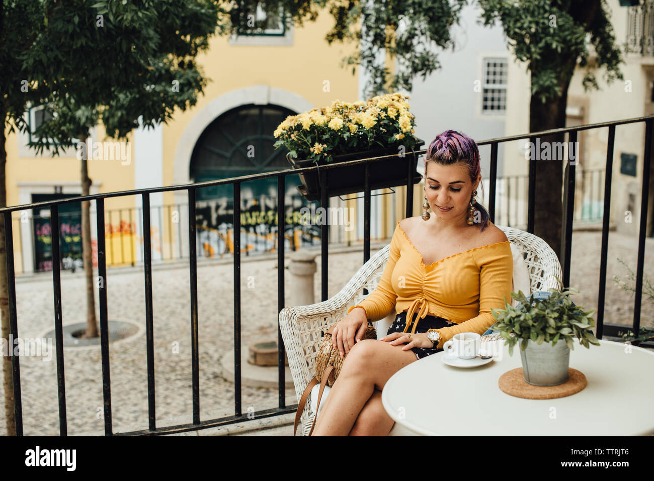Purpl hair girl with a cup of coffee in the street of Lisbon, Portugal Stock Photo