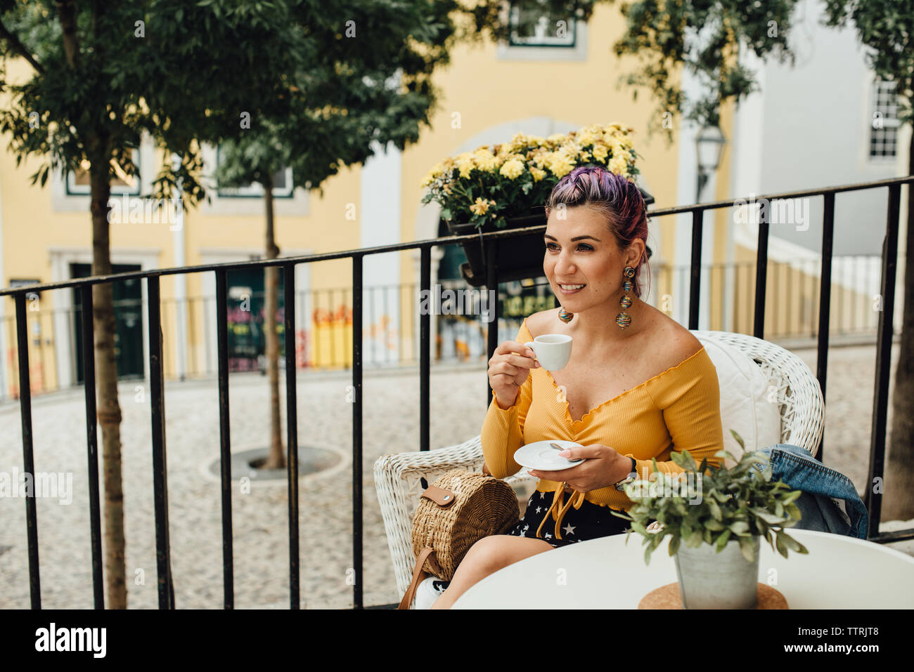Young woman with a cup of coffee in the street of Lisbon, Portugal Stock Photo