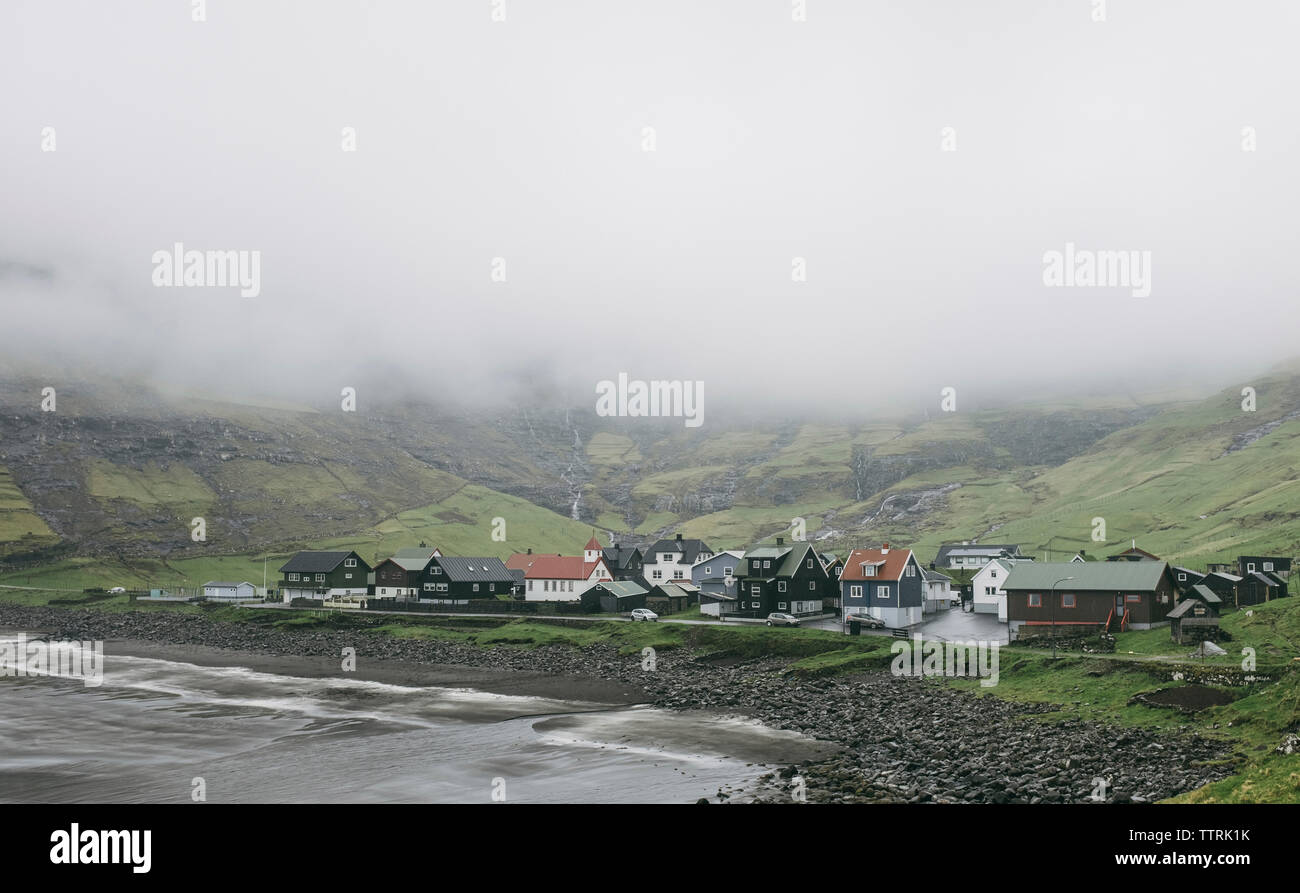 High angle view of village by sea during foggy weather Stock Photo