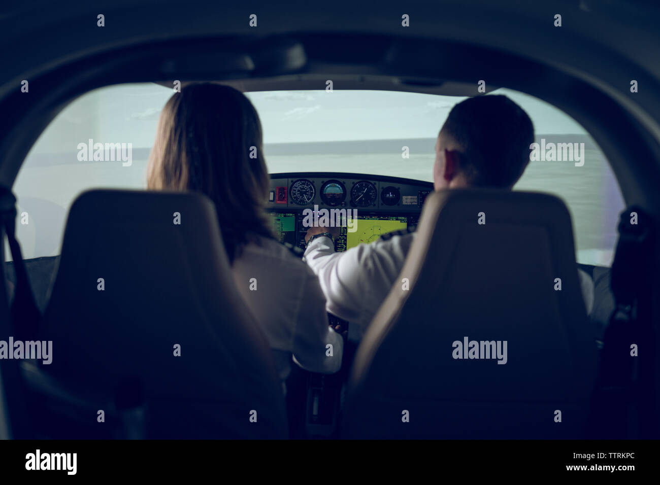 Man navigating virtual airplane in amateur flight simulator Stock Photo -  Alamy