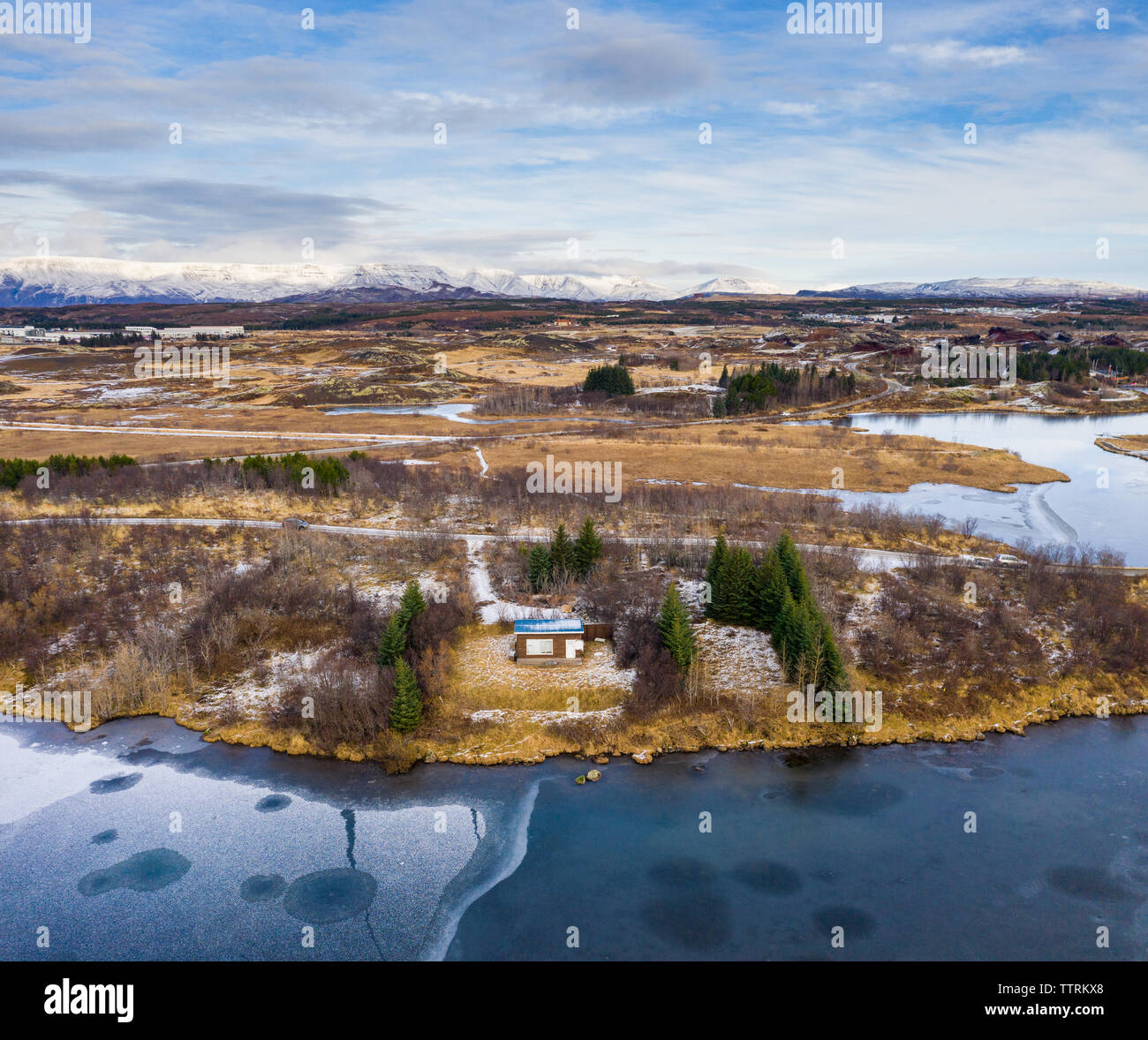 Drone view of country house on coast near water surface and wild lands ...