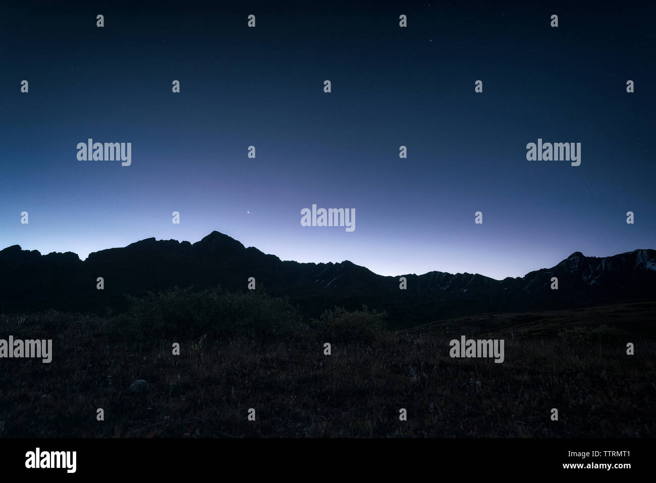 Low angle view of silhouette mountain against sky at night Stock Photo ...