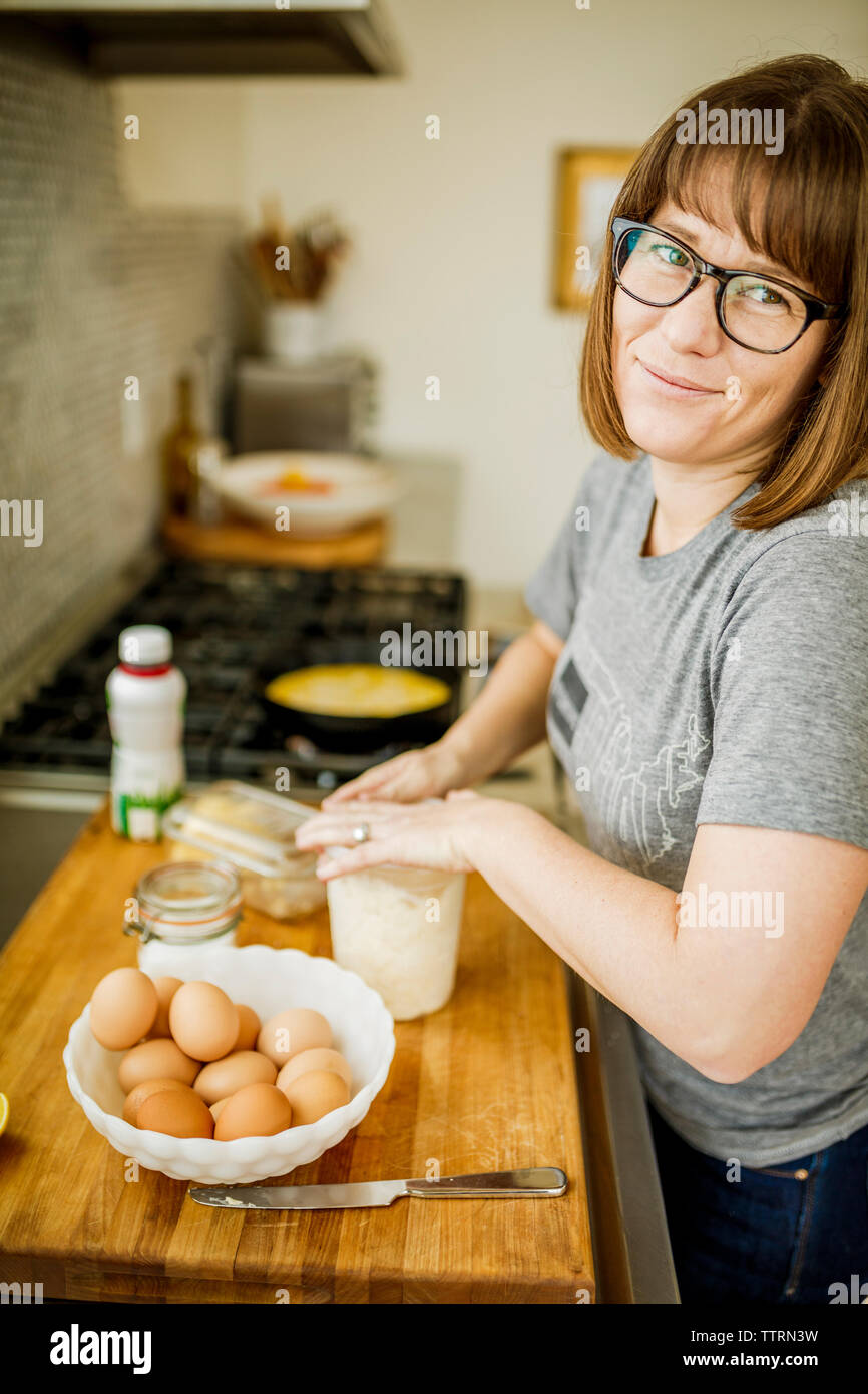 Portrait of woman preparing food at home Stock Photo