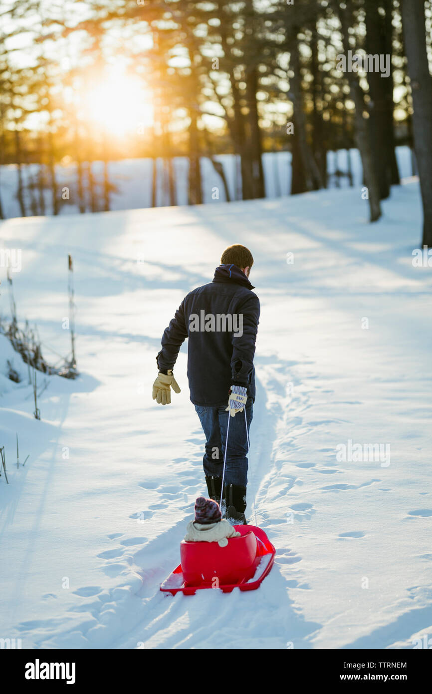 Man pulling sled with ice fishing gear, Wyoming, USA Stock Photo - Alamy