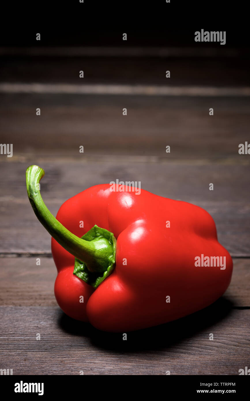 Close-up of red bell pepper on wooden table Stock Photo