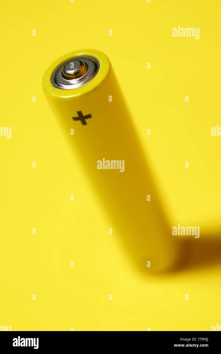 High angle view of battery on yellow background Stock Photo