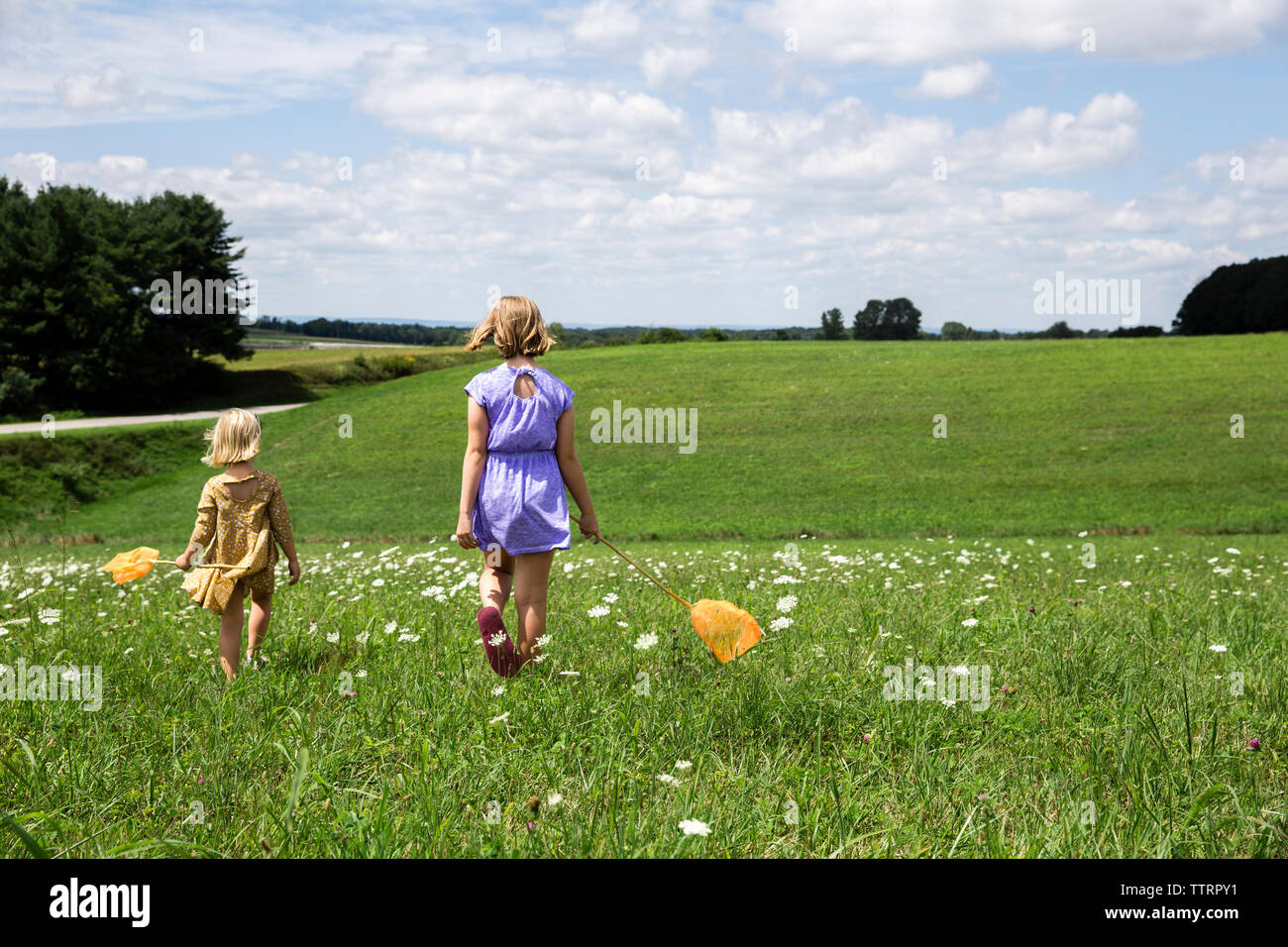Rear view two girls walking hi-res stock photography and images - Alamy