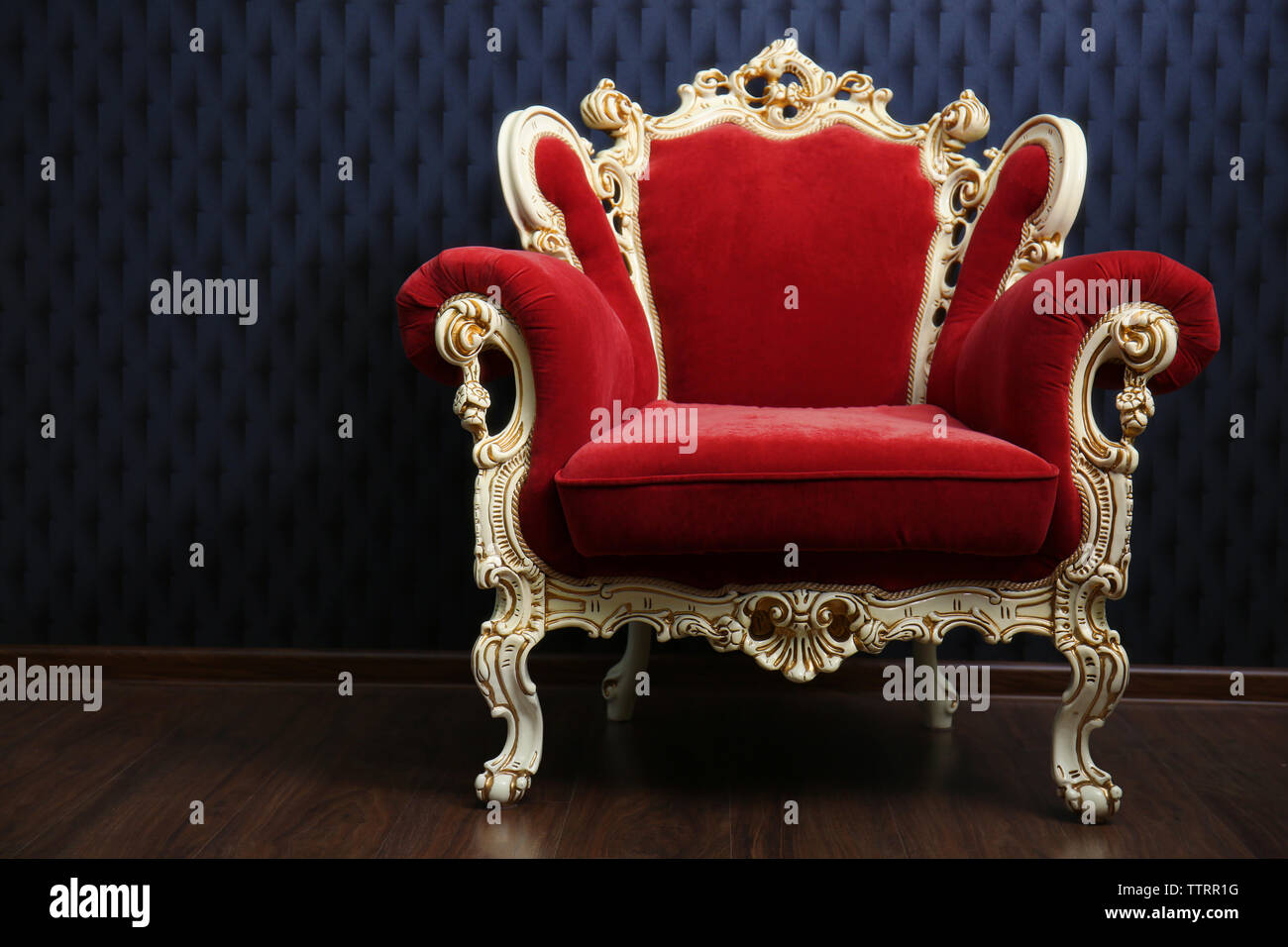Luxury red armchair on dark background Stock Photo - Alamy