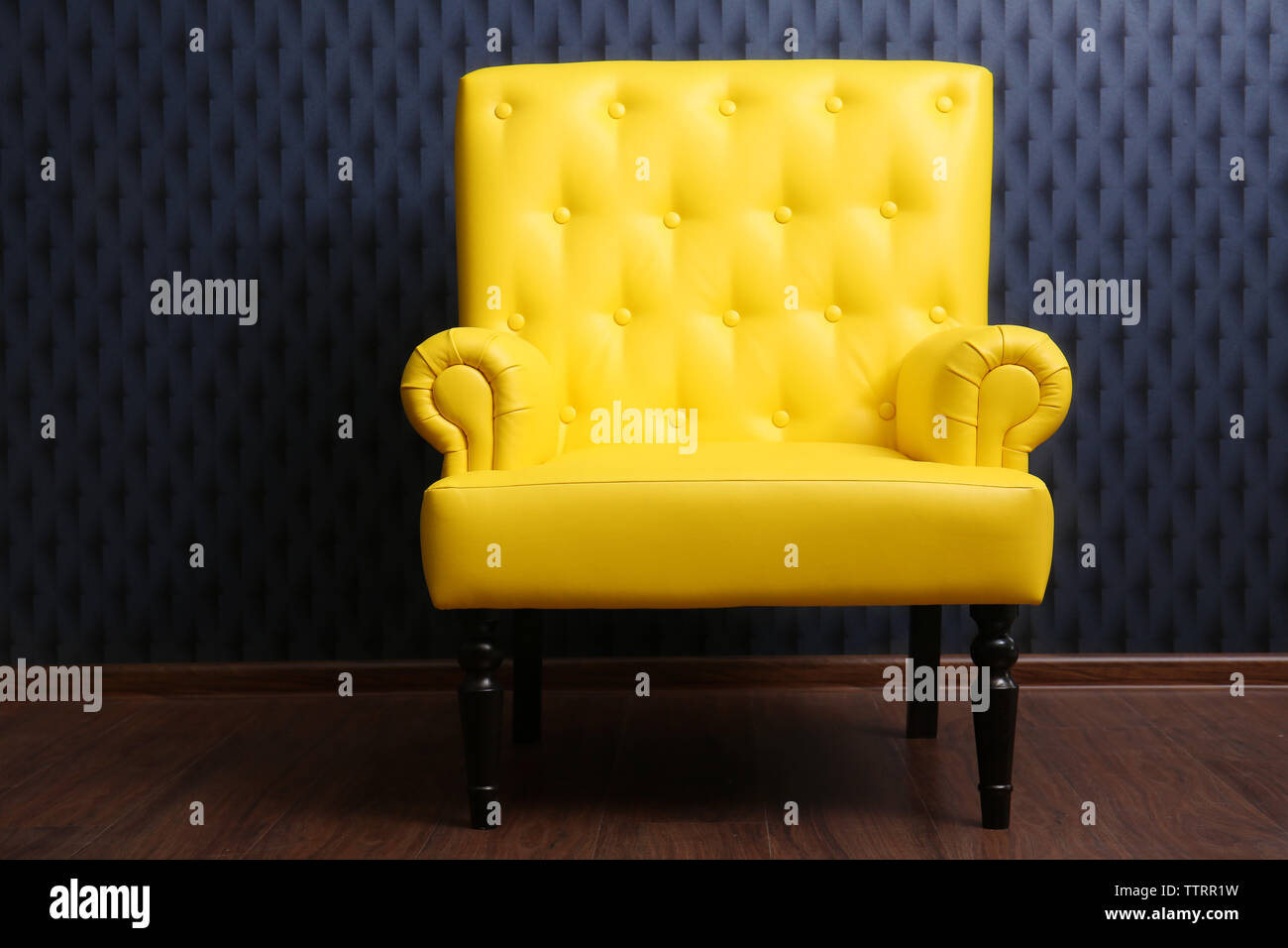 Modern yellow armchair on dark background Stock Photo Alamy