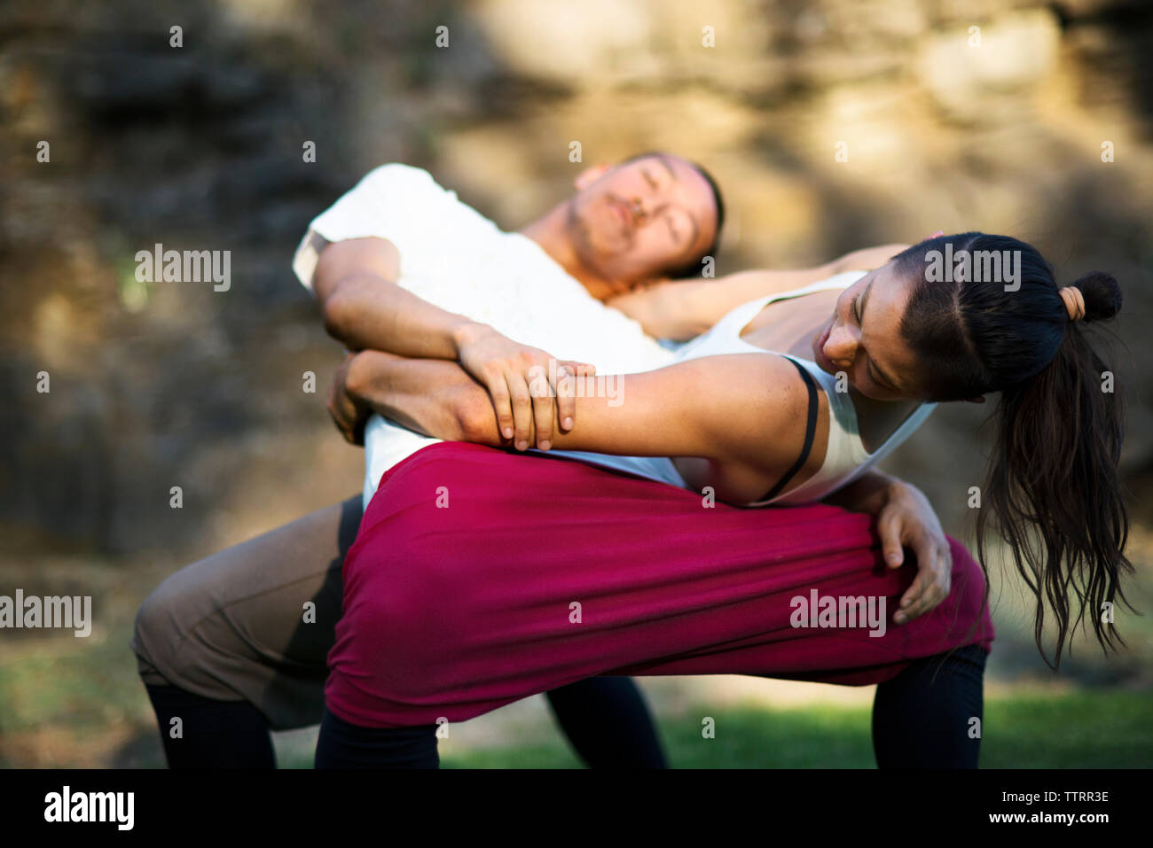 Affectionate couple embracing while practicing dance on field Stock Photo