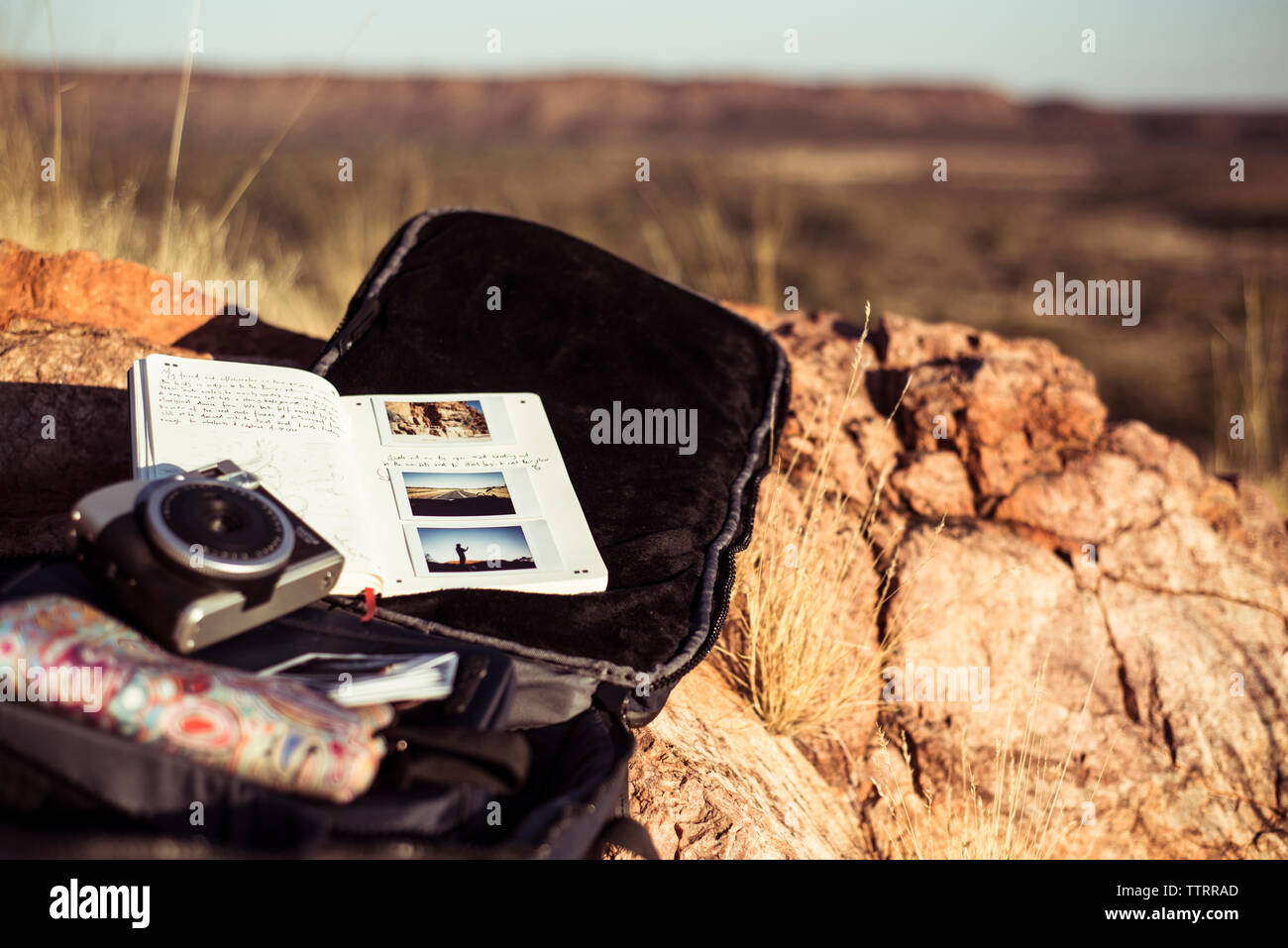 High angle view of camera with personal accessories on rock Stock Photo
