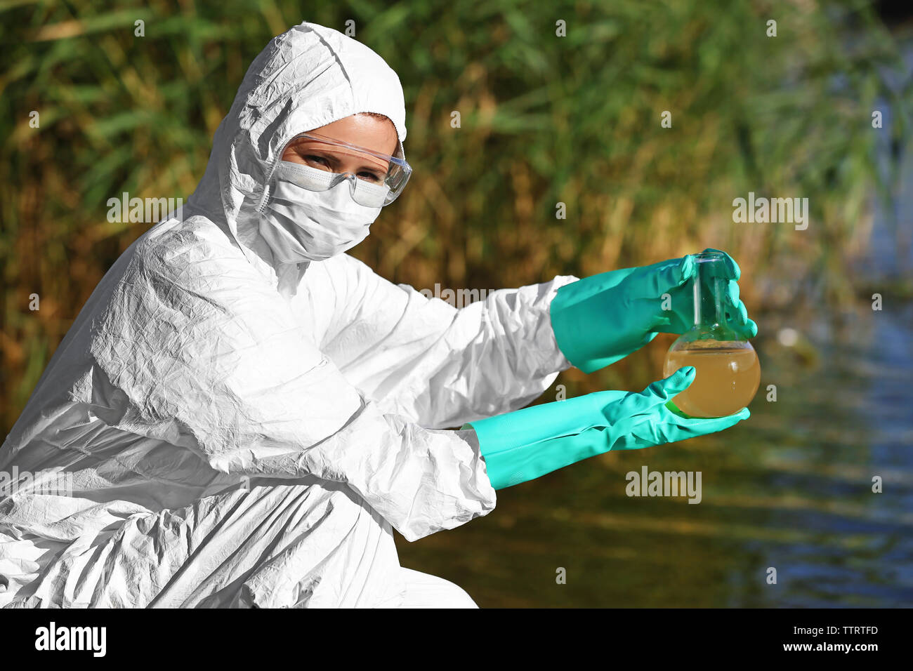 Woman with flask for expertise. Environmental pollution concept Stock Photo