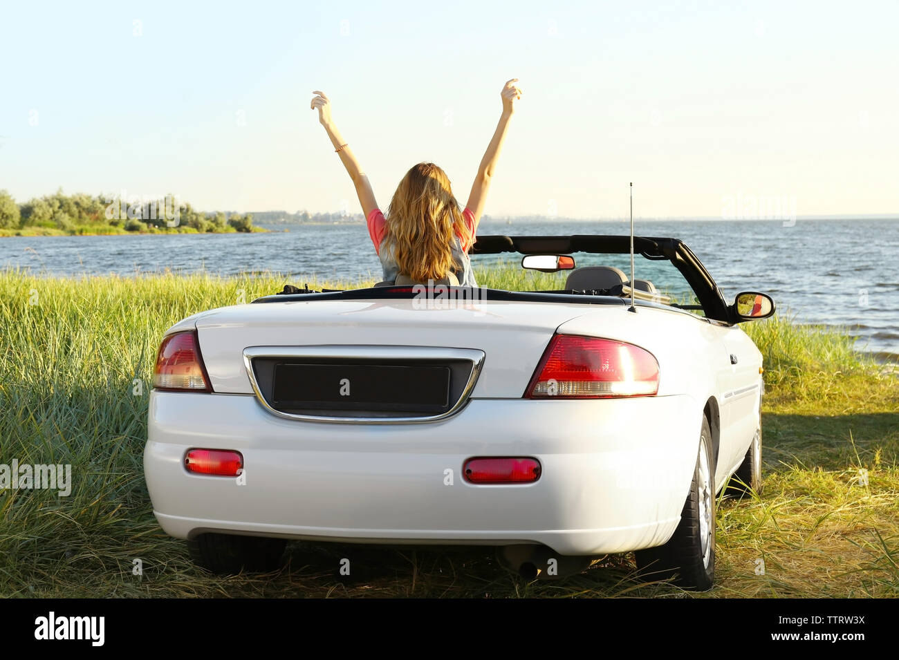 Happy girl in car Stock Photo - Alamy