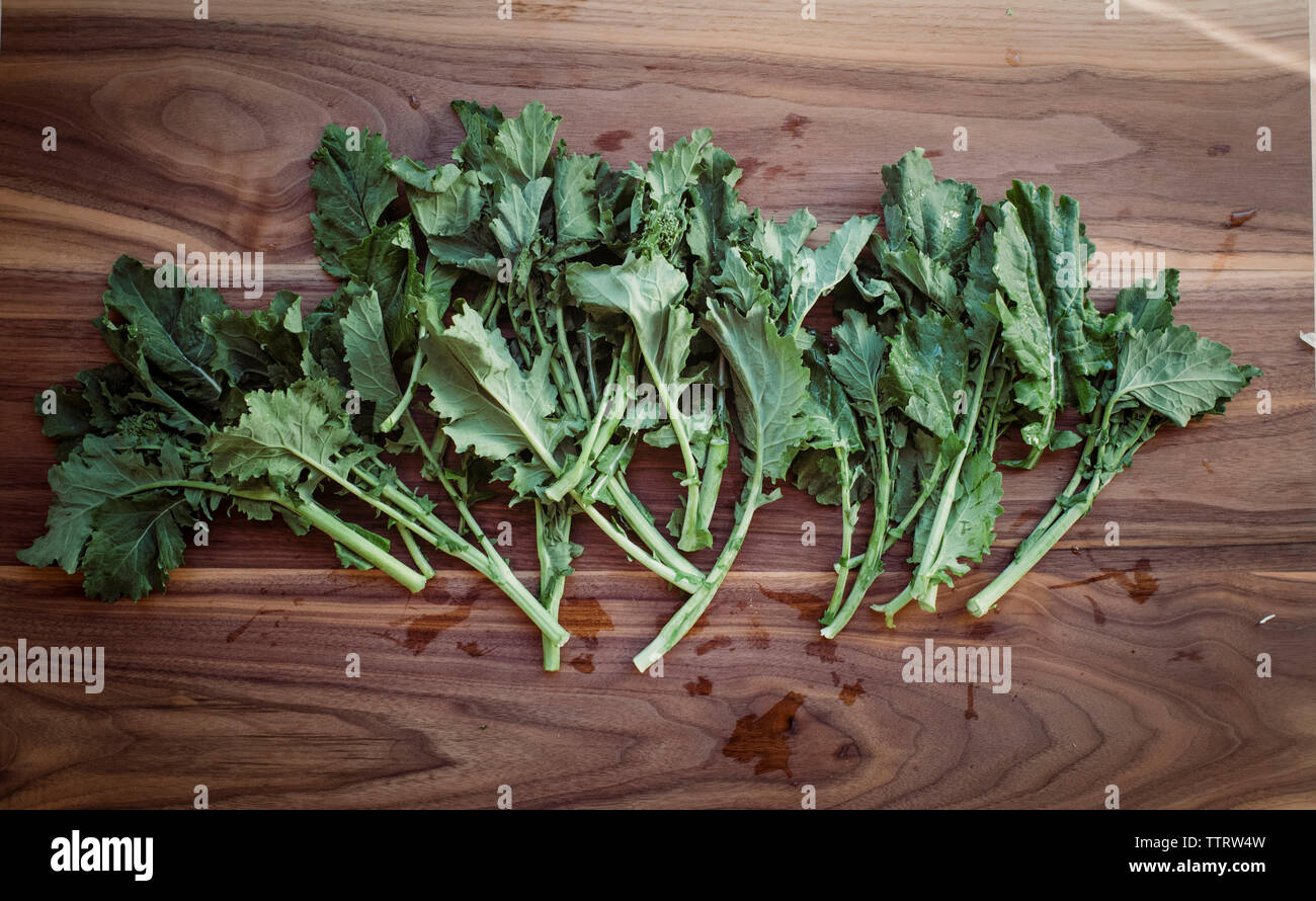 Overhead view of fresh turnip leaves on wooden table Stock Photo
