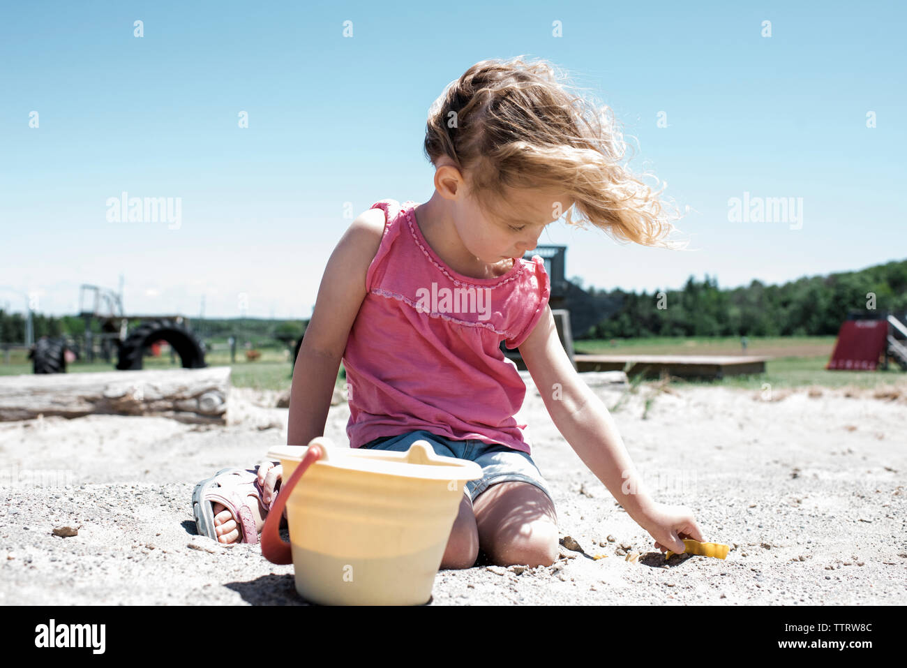 Girl kneeling in the sand hi-res stock photography and images - Alamy