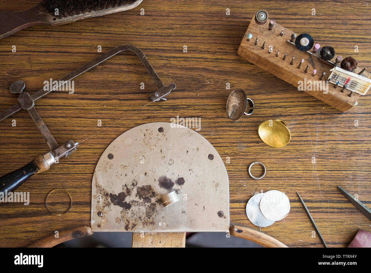 Overhead view of work tools with ring on wooden workbench in workshop Stock Photo