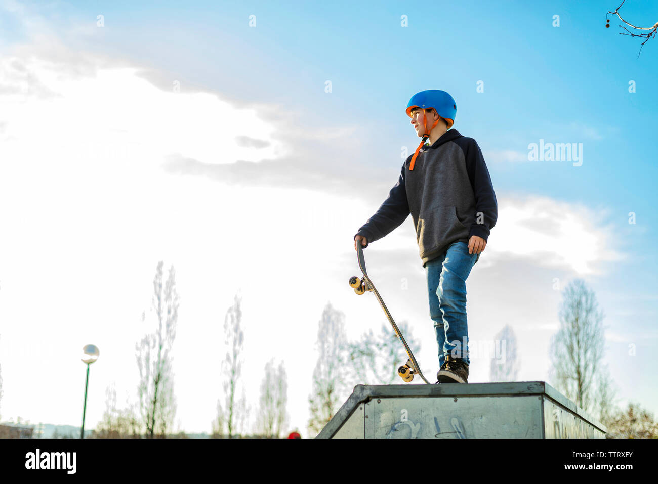 Low view of young skater on skate ramp ready to perform a trick Stock Photo