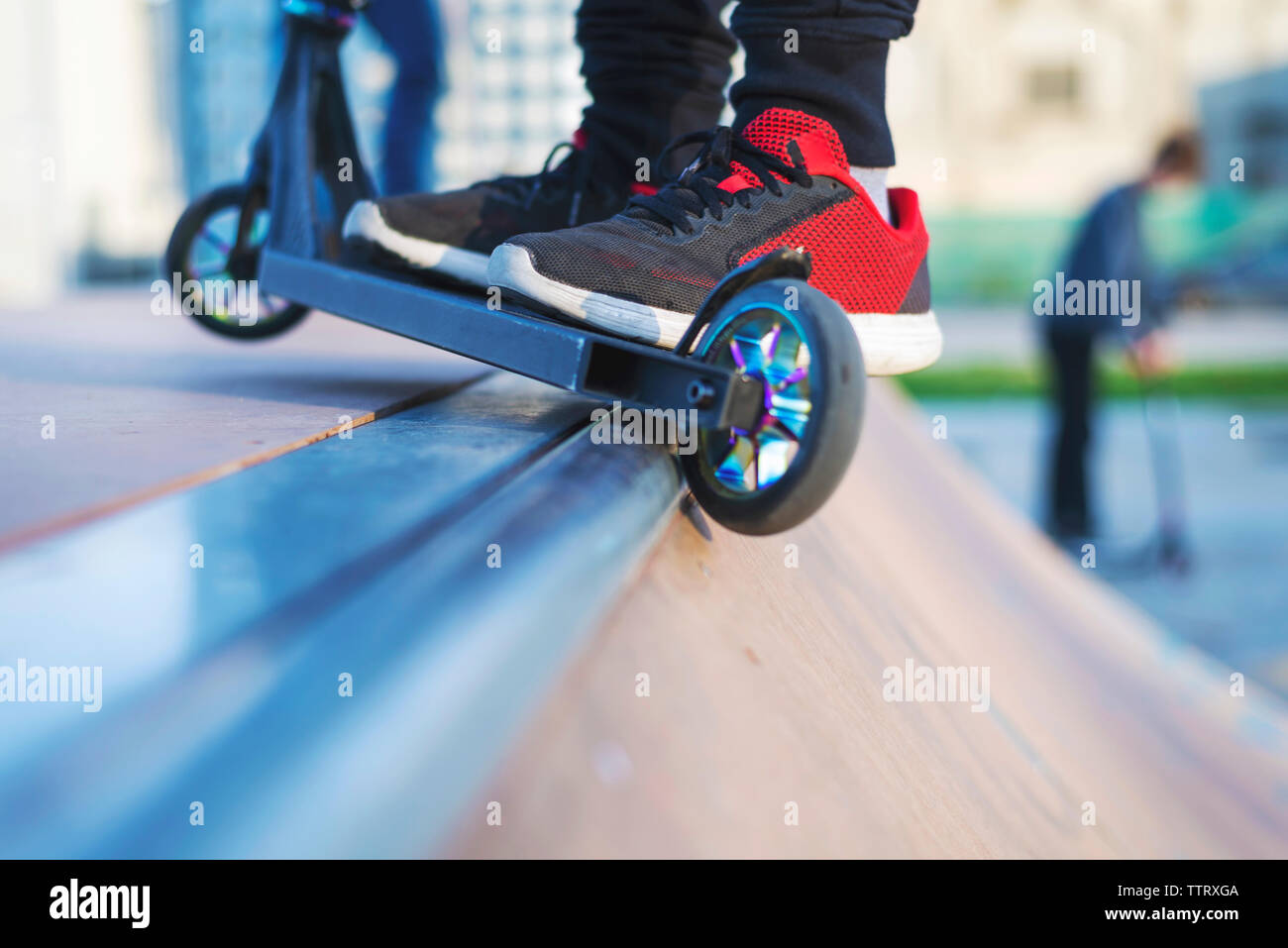Close up of a scooter on skateramp coping Stock Photo