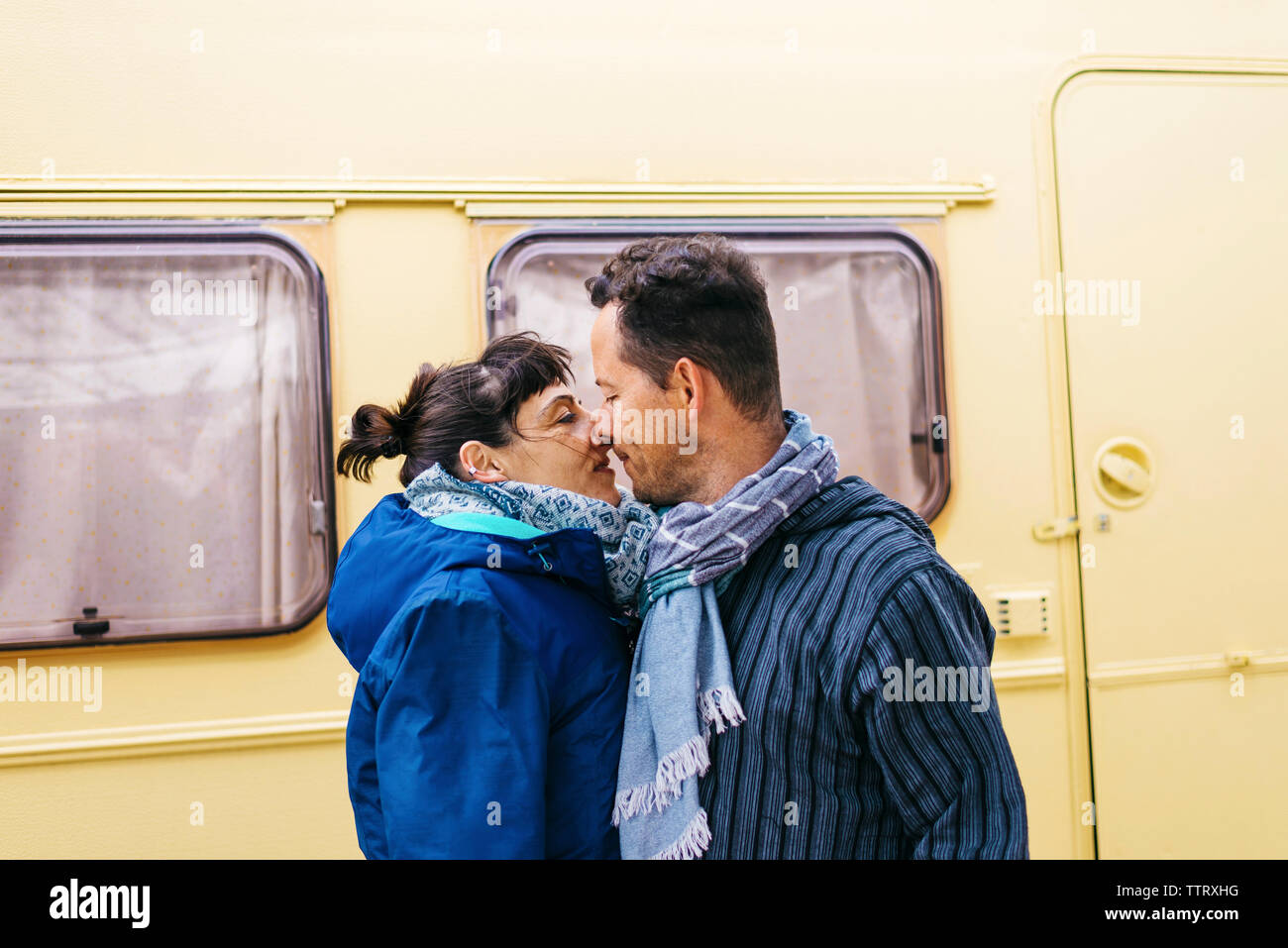 Couple standing while kissing outdoors Stock Photo