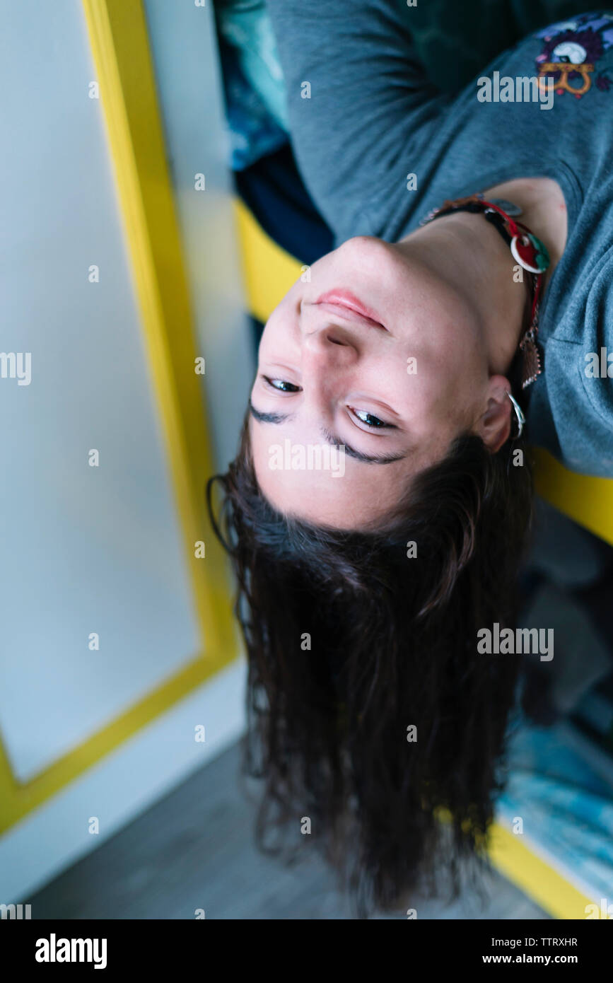 Young girl lying down on bed, looking camera into a motorhome Stock Photo
