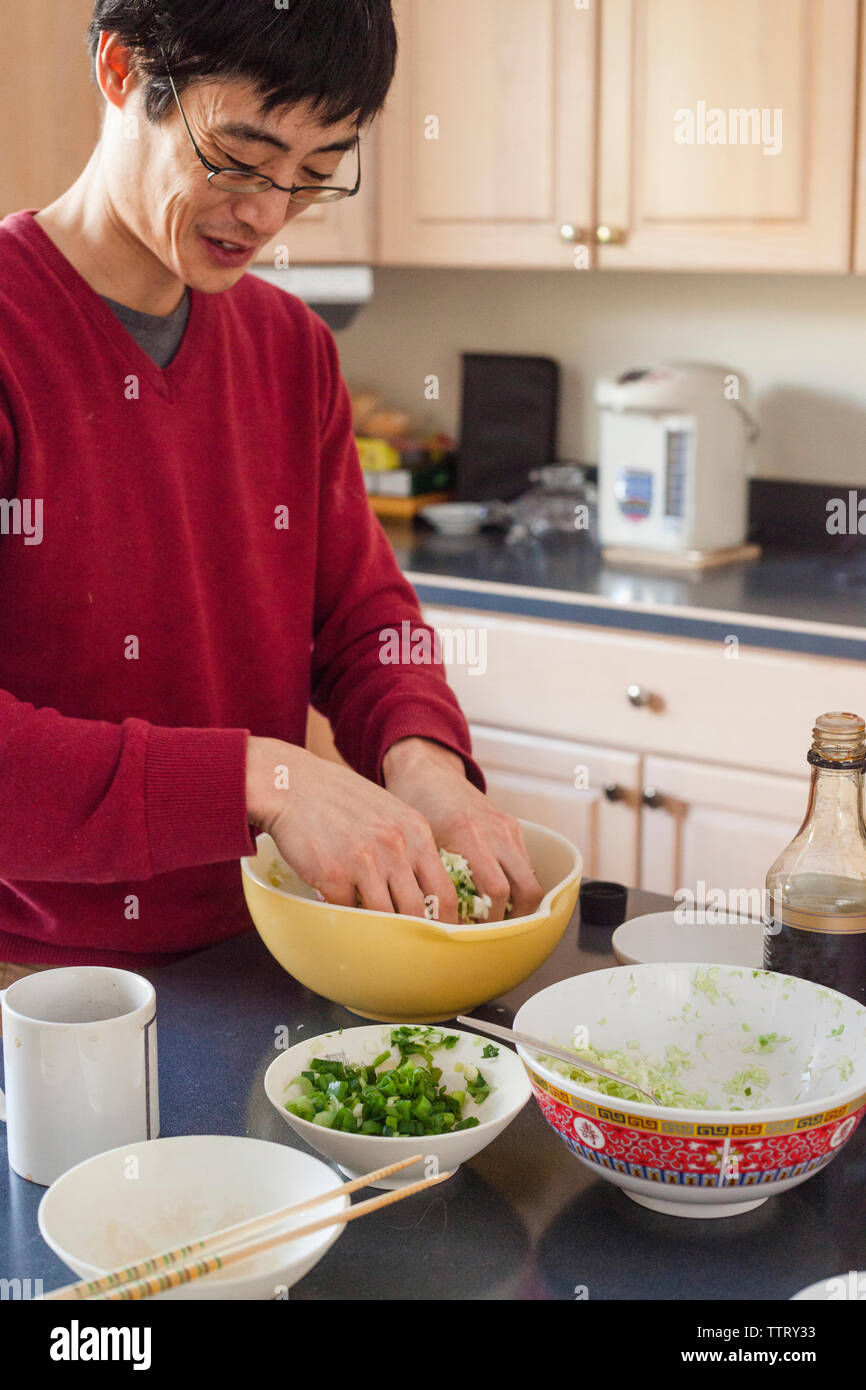 Man preparing food in kitchen at home Stock Photo
