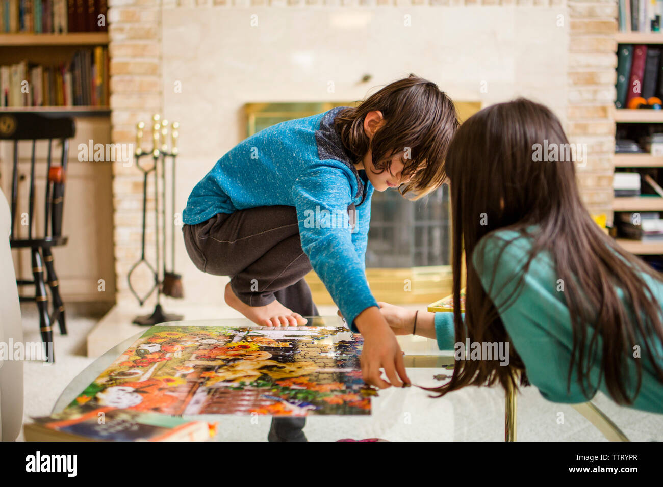 Brother and Sister doing a puzzle together on the floor Stock Photo Alamy