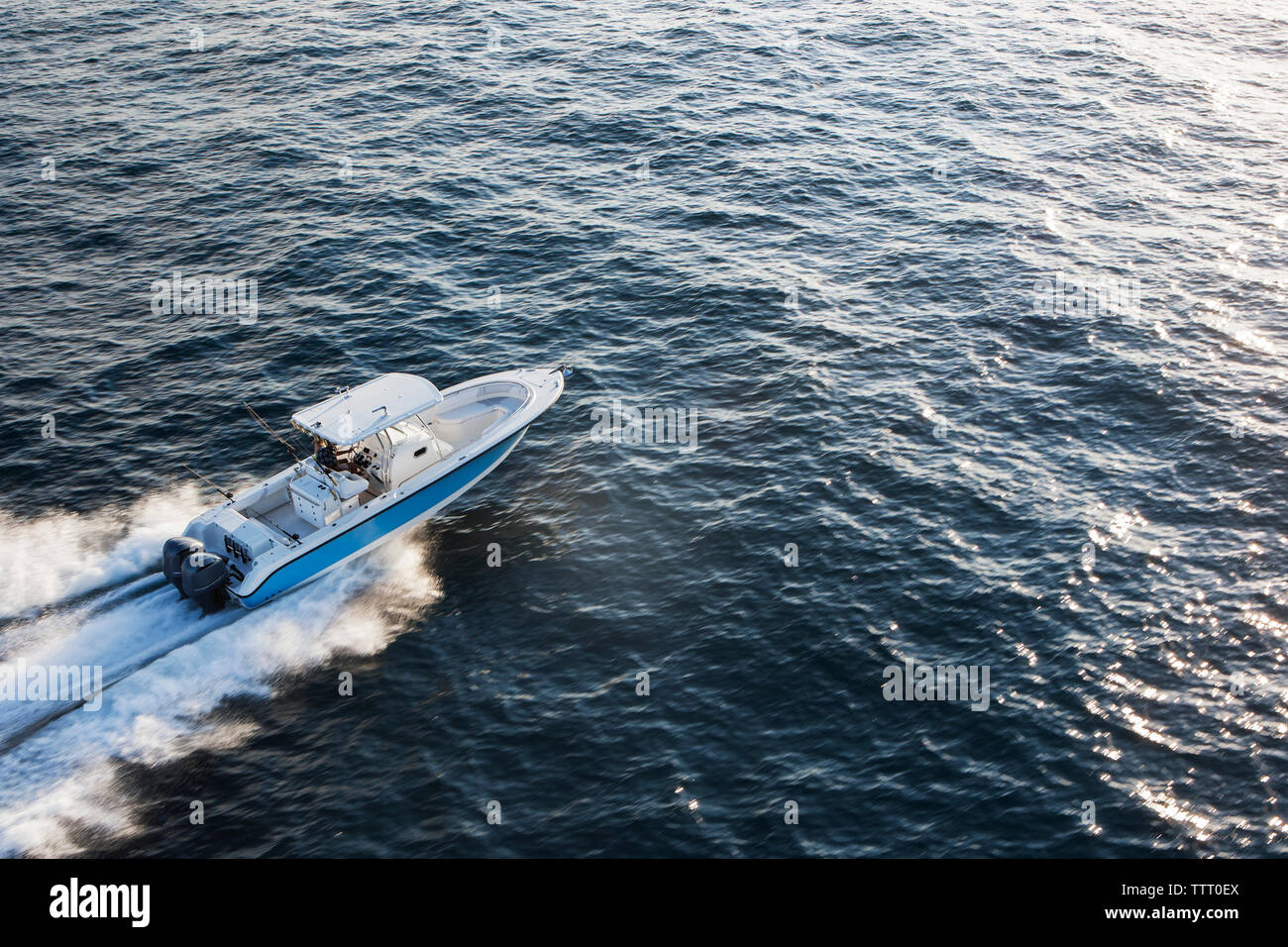Aerial view of couple driving speedboat on sea Stock Photo