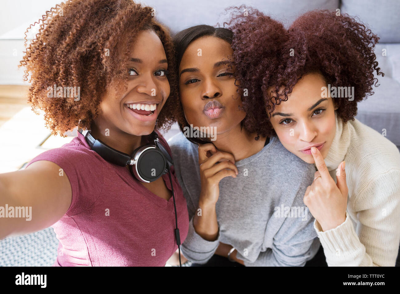 Portrait of playful female friends at home Stock Photo - Alamy