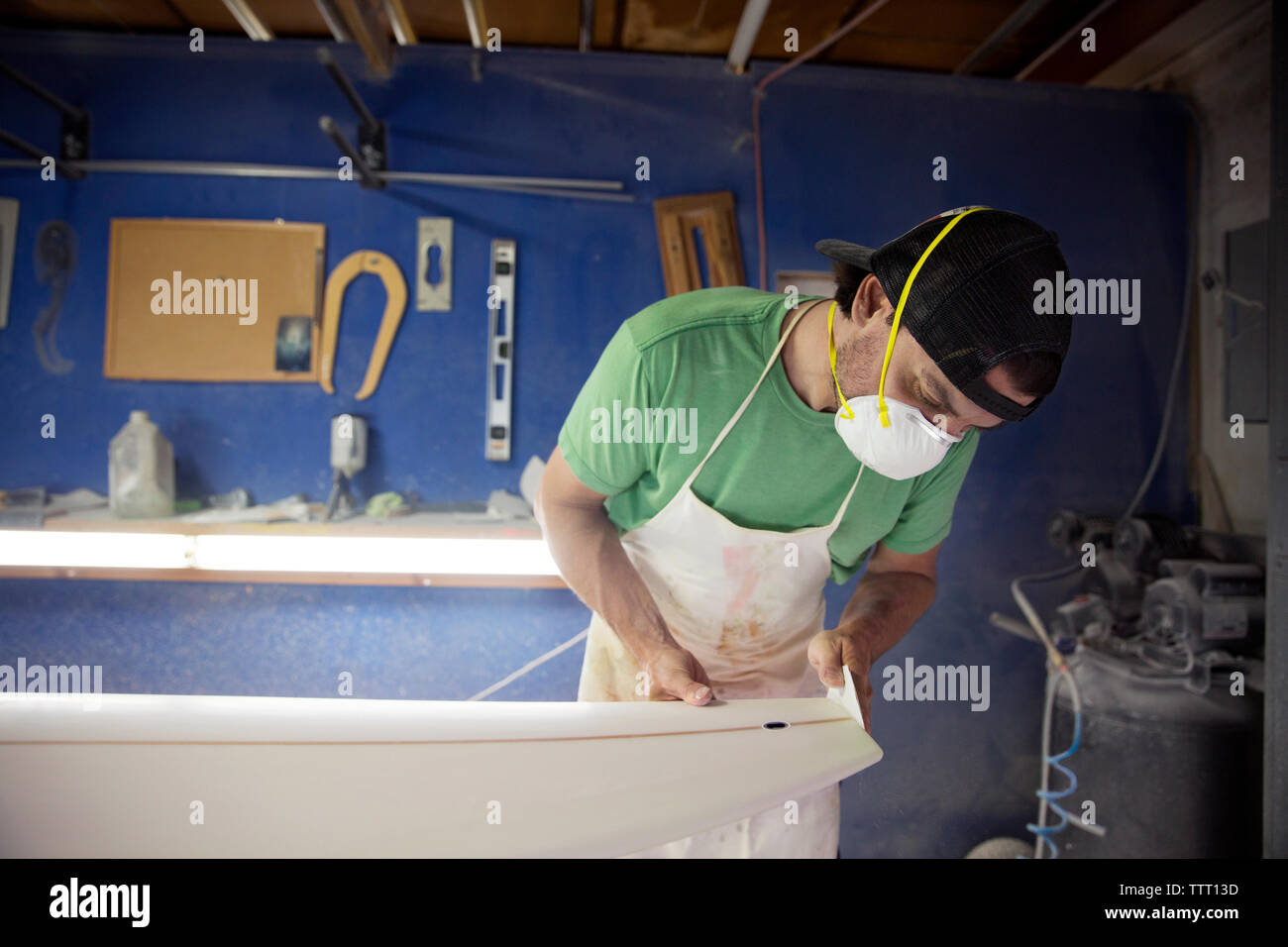 worker making surfboard in workshop Stock Photo