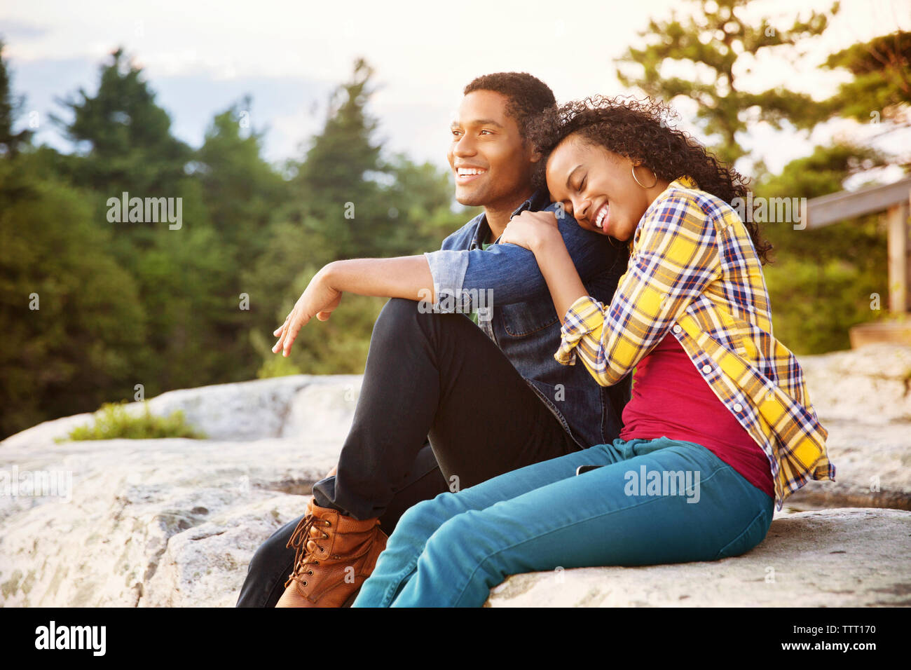 Male and female sitting on rock hi-res stock photography and images - Alamy