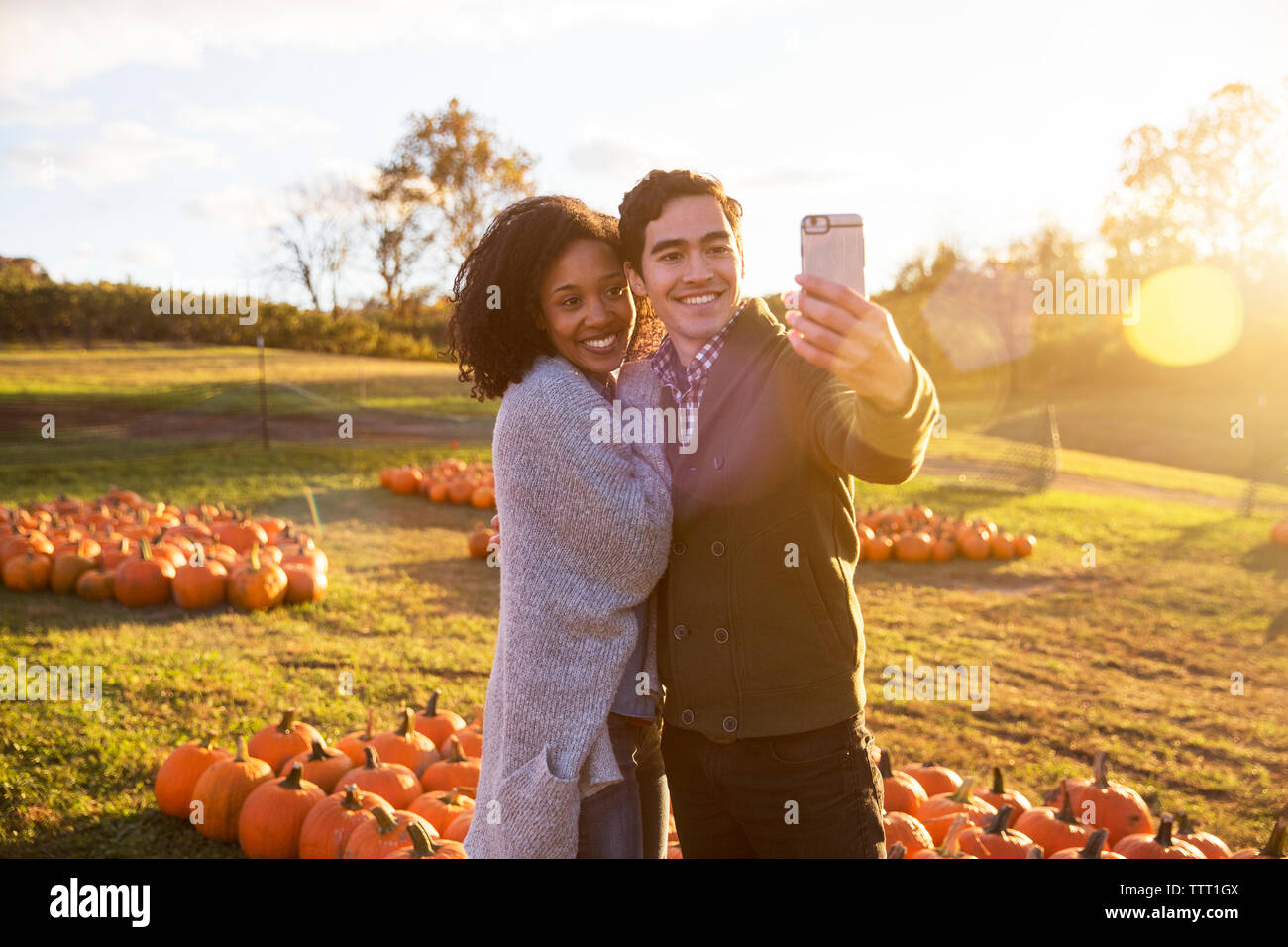 Couple taking while standing in farm Stock Photo - Alamy