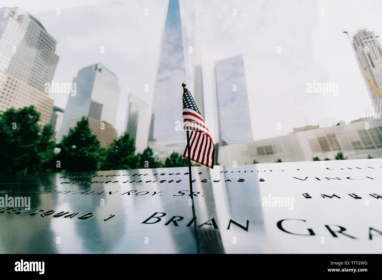 American flag on memorial with One World Trade Center in background Stock Photo