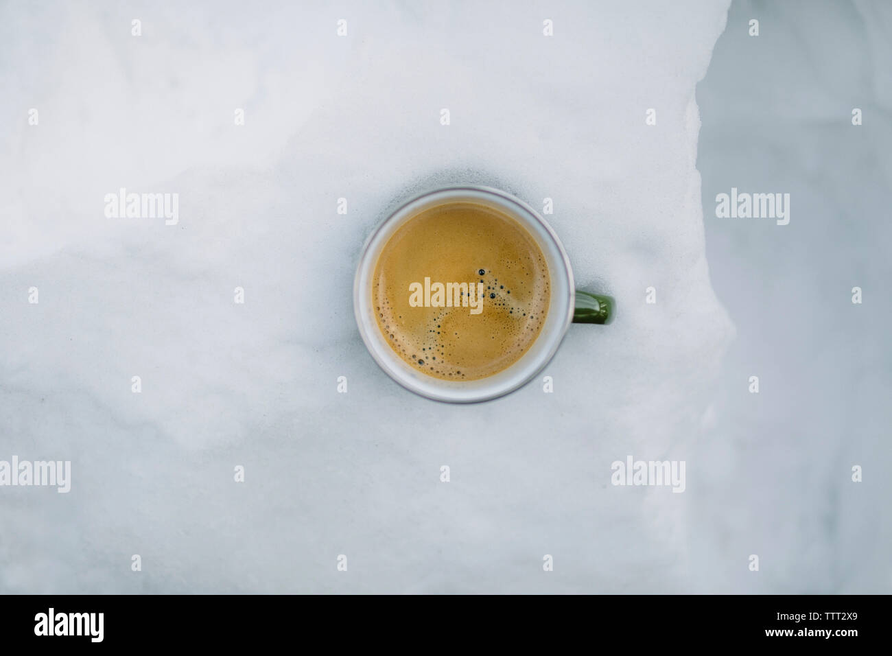 Overhead view of coffee cup in snow Stock Photo