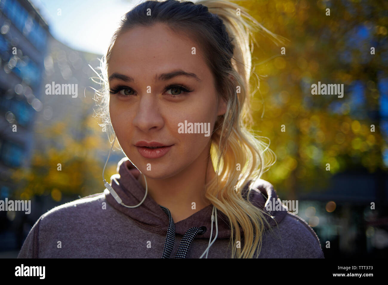 Close-up portrait of confident woman in sports clothing standing in city Stock Photo