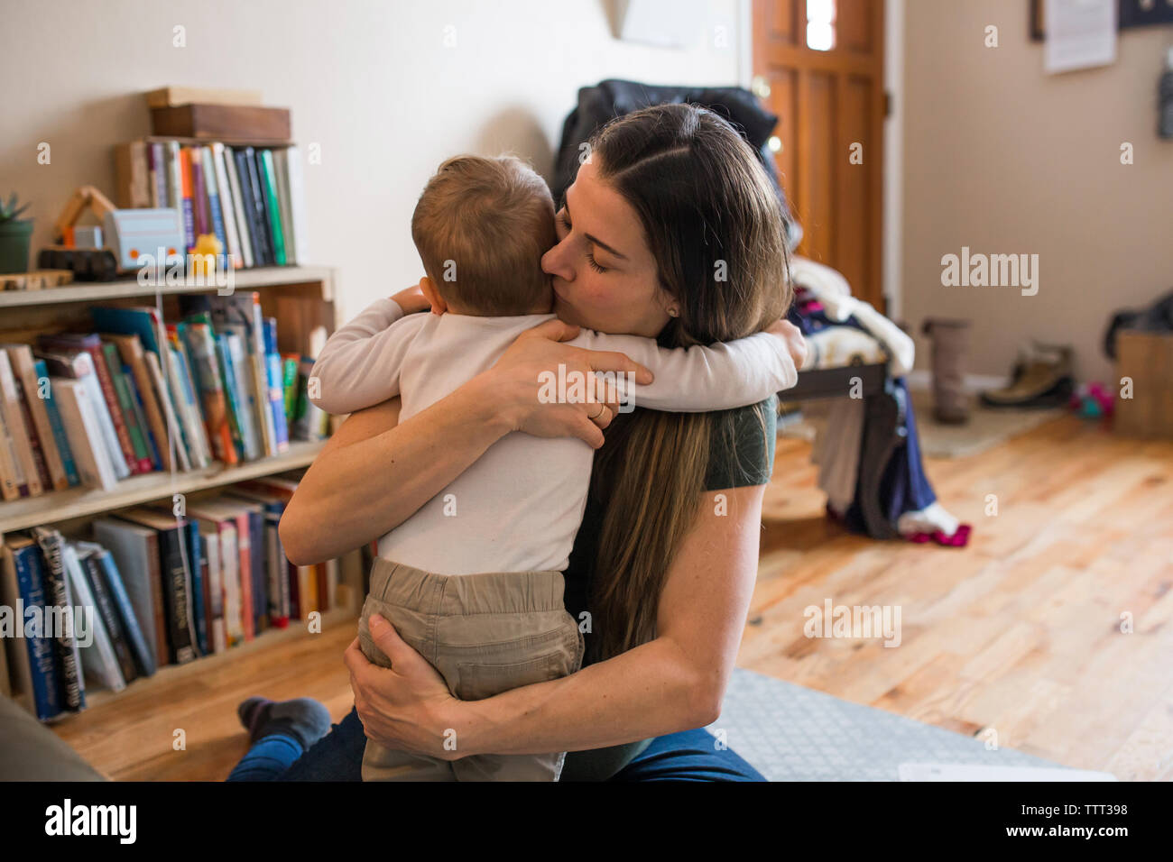 Pregnant mother embracing son at home Stock Photo