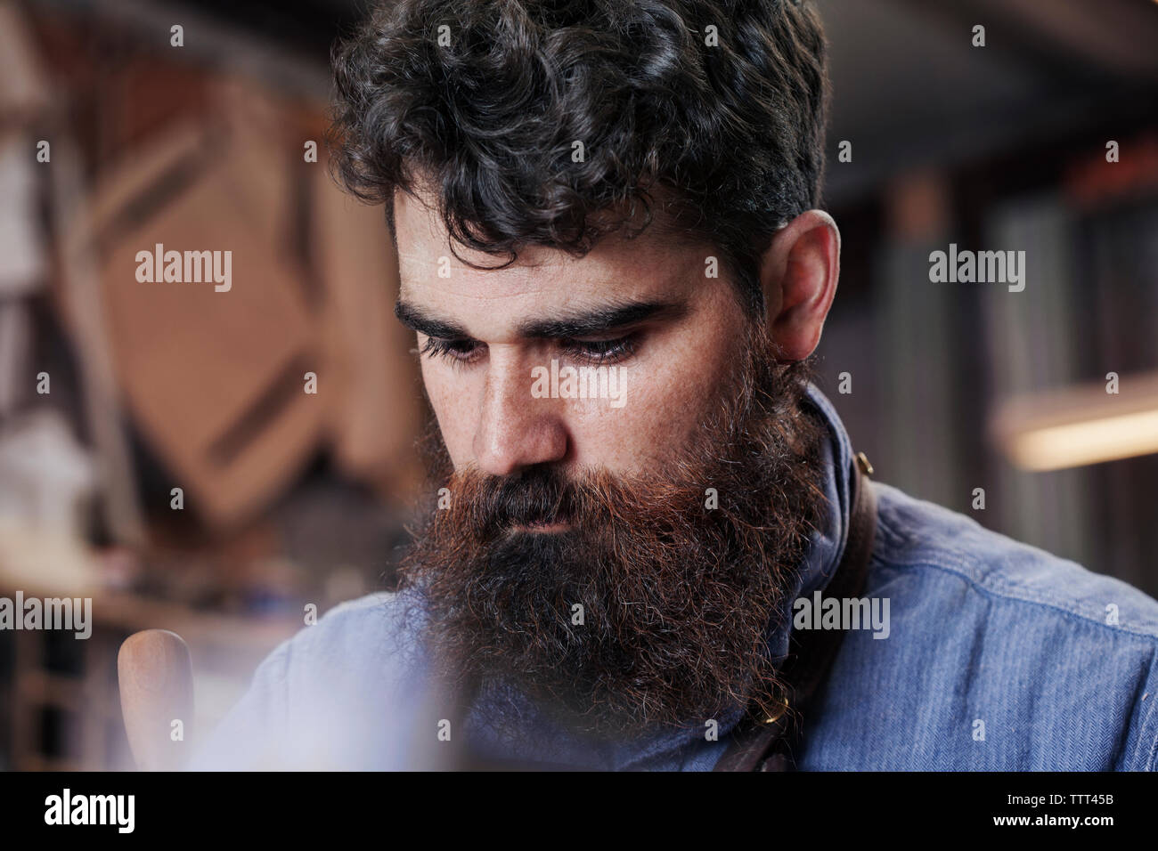 Close-up of serious bearded man at workshop Stock Photo