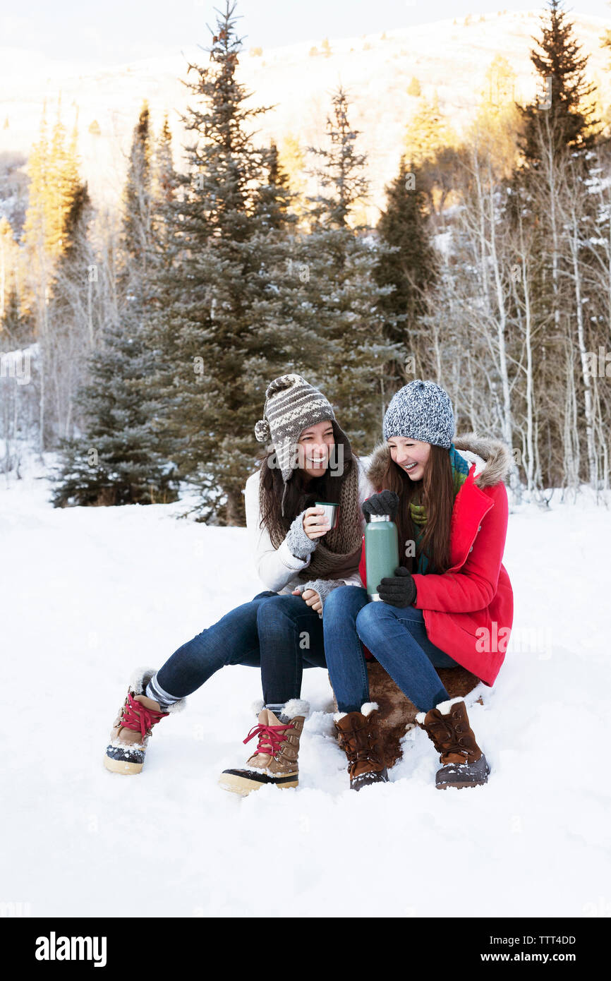 Girl sitting rock in snow hi-res stock photography and images - Alamy