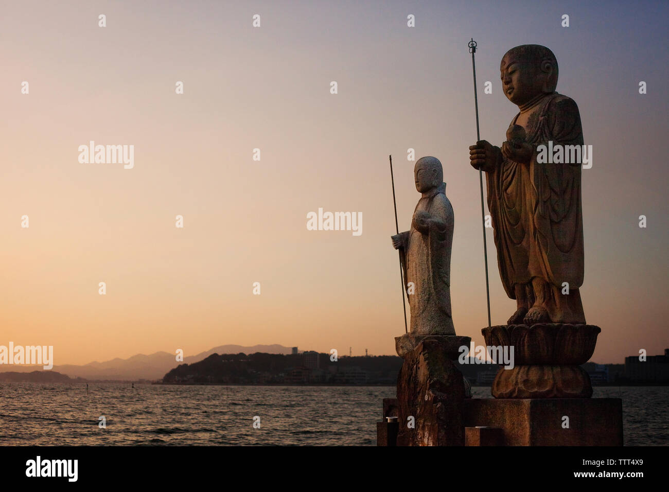 Sculptures by Lake Shinji against clear sky during sunset Stock Photo