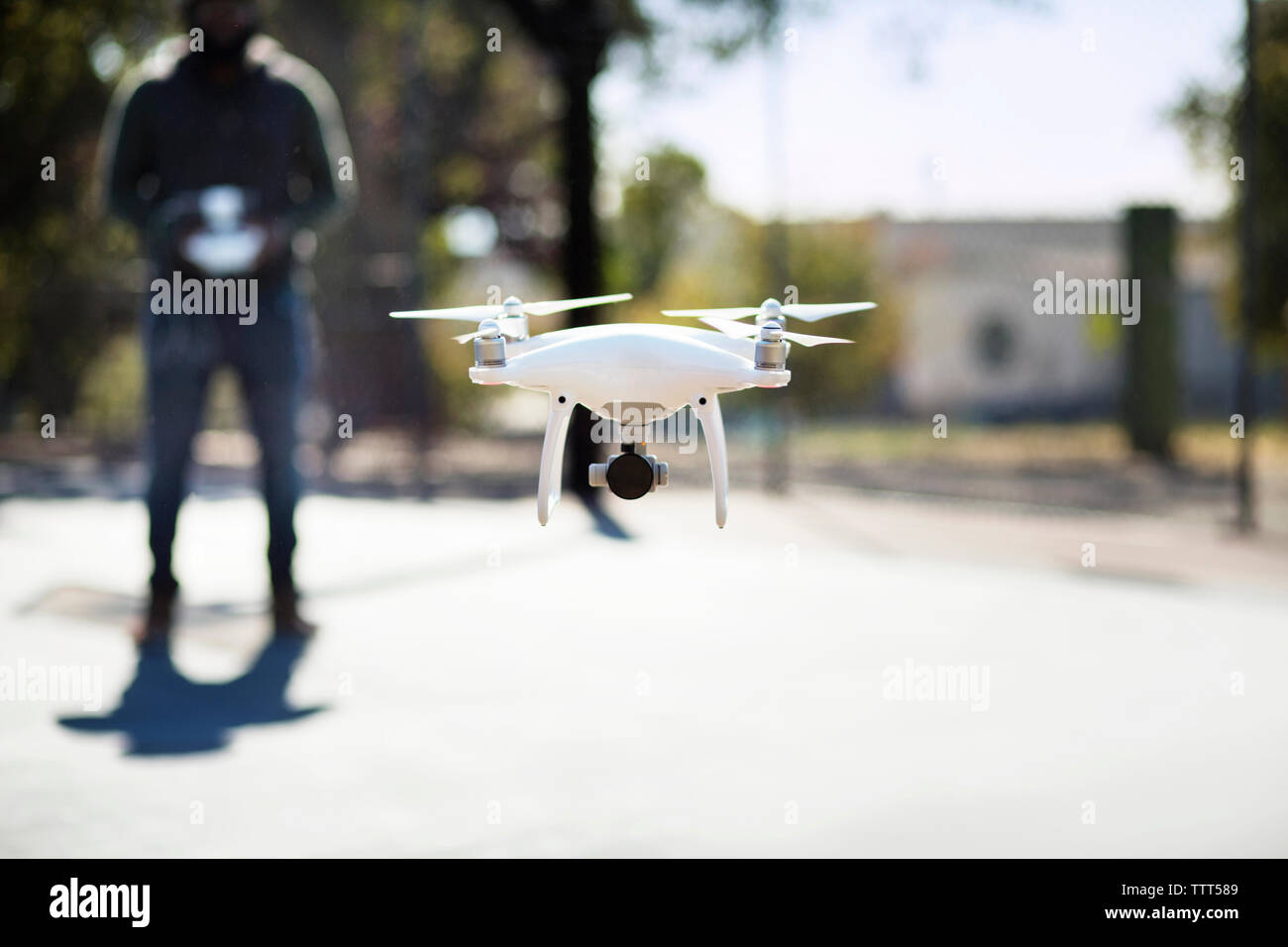Close-up of drone operated by man in basketball court Stock Photo