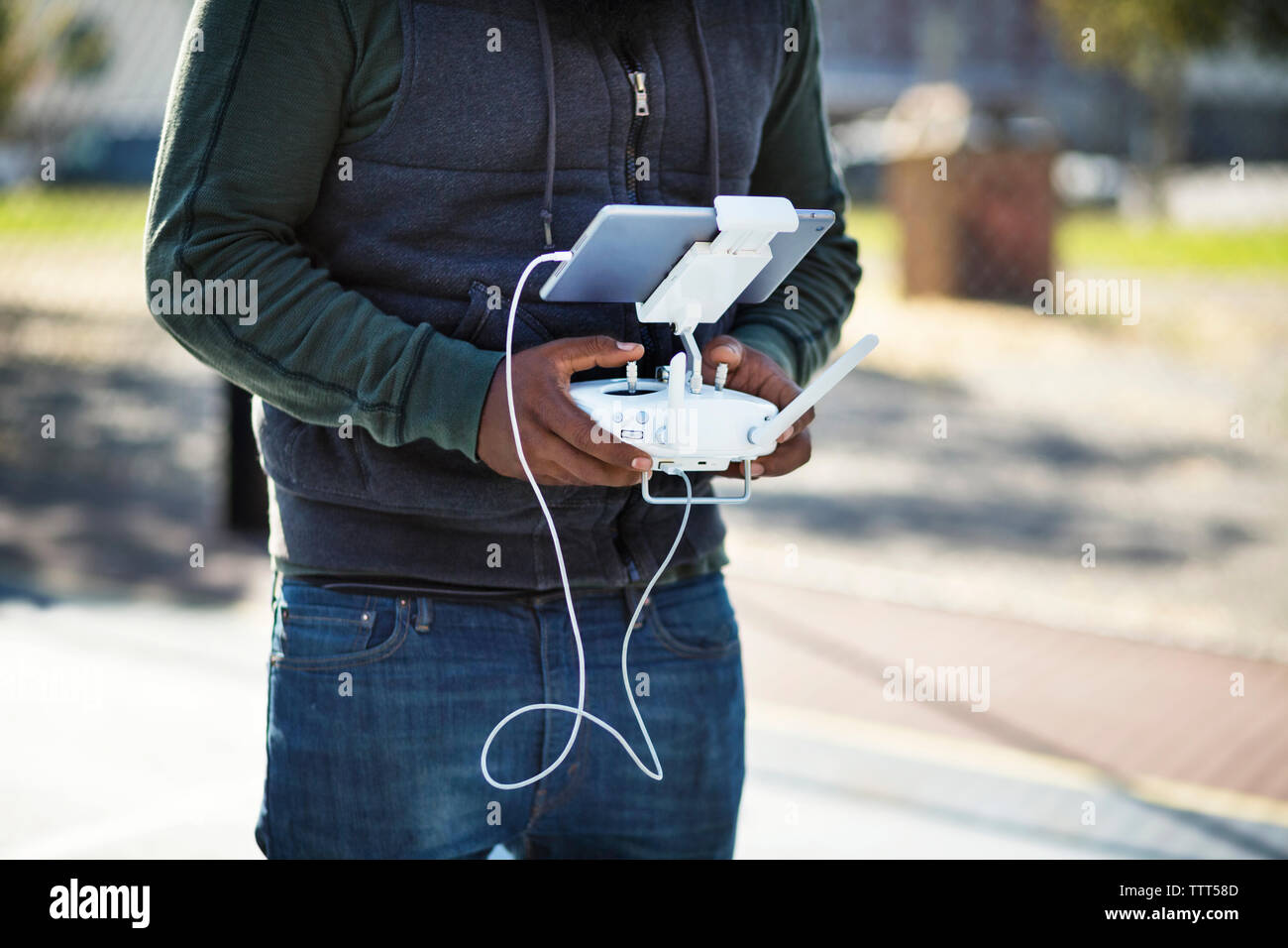 Midsection of man operating remote control Stock Photo