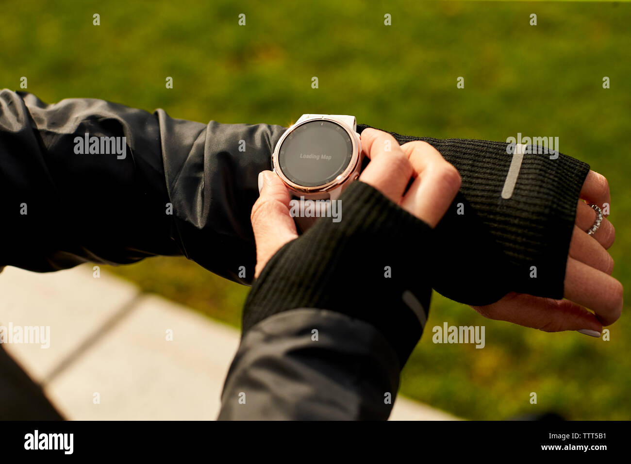 A close up of a woman's hand interacting with her fitness watch. Stock Photo
