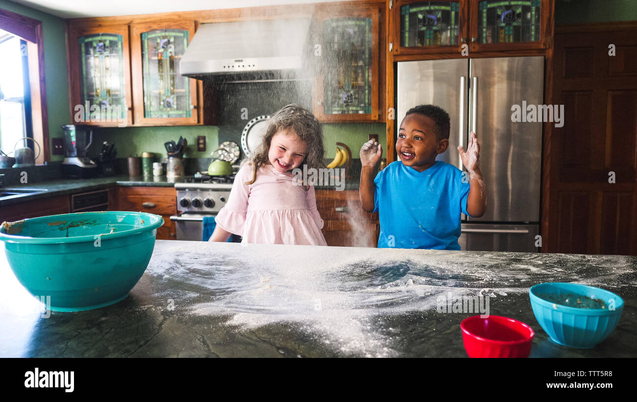 Kids making a messing the kitchen Stock Photo