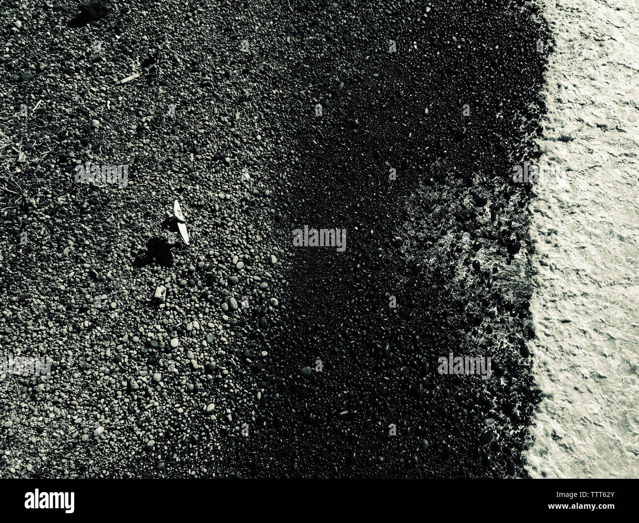 Aerial view of a man walking with his surfboard on the beach Stock ...