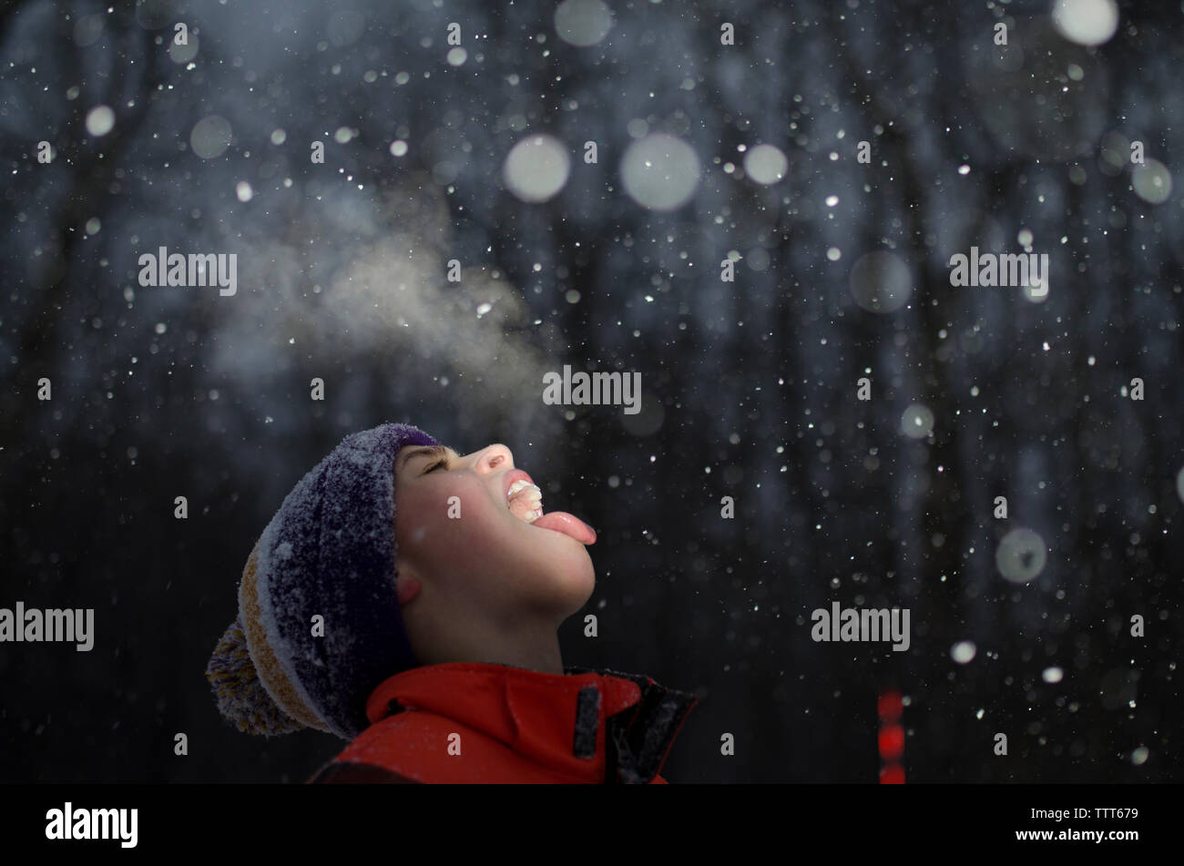 Boy with mouth open during snowing Stock Photo