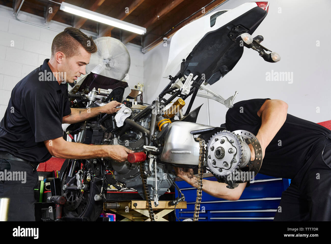 Workers making motorcycle in workshop Stock Photo - Alamy
